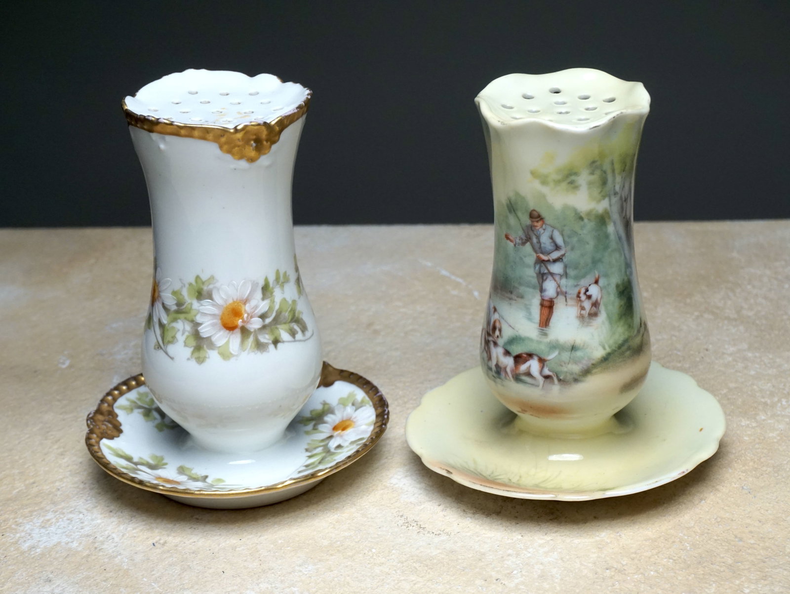 Antique hatpin holders, French and German c. 1910 lot of 2: Depicting a gilt and floral decorated motif and the other depicting a figural hunting scene. 4.75" and 4.5" Provenance: Reimer Family Collection. Wilmette, IL
