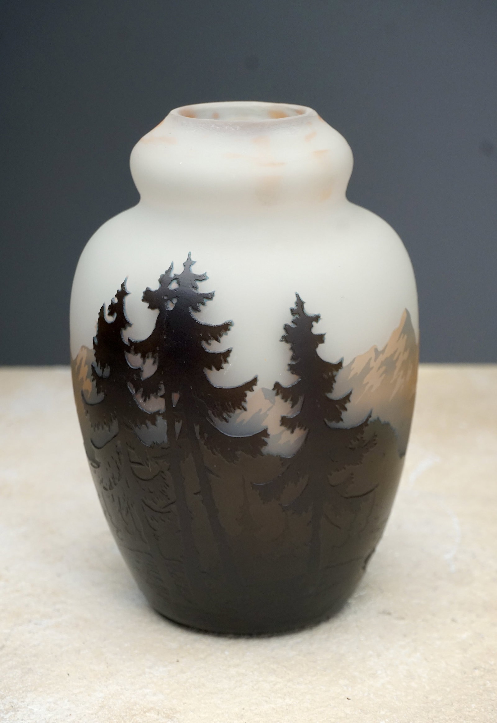 A Müller Freres cameo glass cabinet vase: A wonderful vase c.1890- 1900 signed Müller Freres forrest landscape cameo glass vase. Depicting a mountainous and forested scene of likely Switzerland. Exquisite workmanship. 5.5" tall. Provenance: