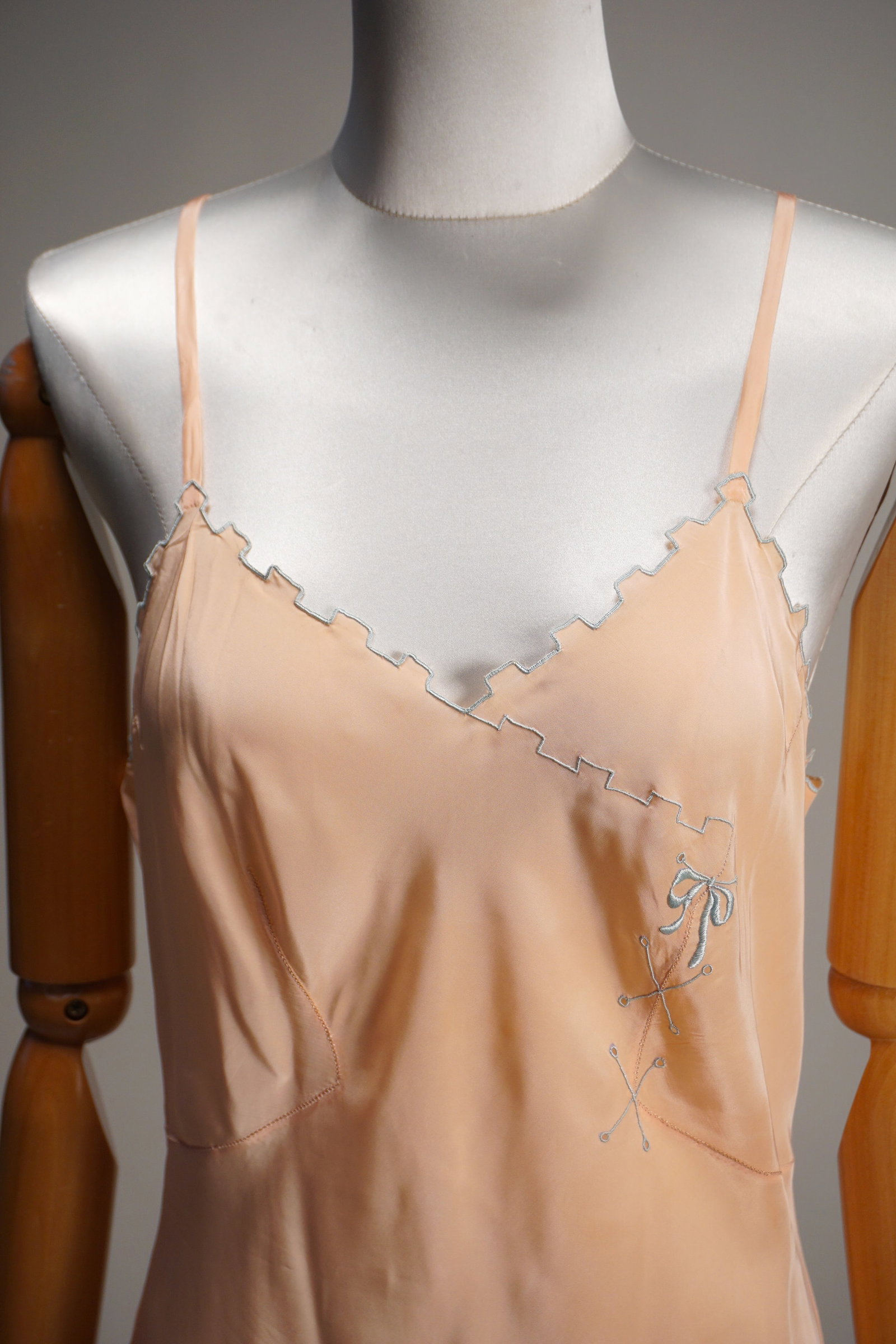 Vintage 1930s lingerie dress with blue stitching, bows, unworn: Antique, vintage 1930s rayon silk blend lingerie dress with unique blue stitching hem along the bust and bow. Unworn with original label. Measures: 34” bust, 28” waist.