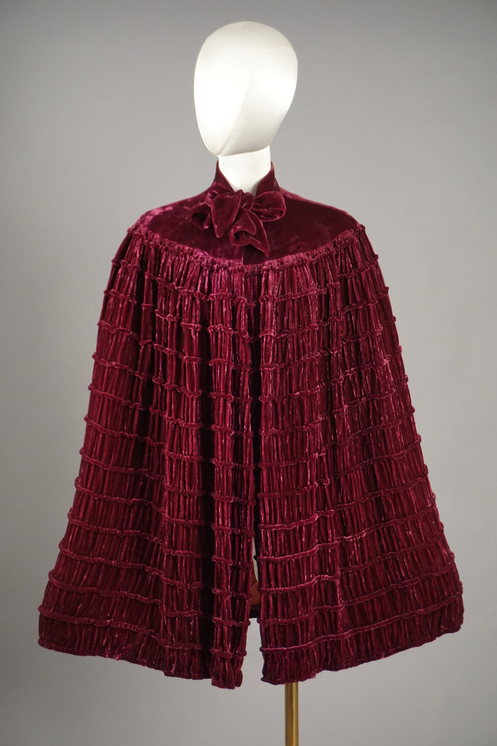 Vintage 1930s Purple Velvet Cape Coat with Label: Vintage 1930s ruched and scalloped purple velvet pelerine mantle cape. Label: The Crossways Shop, Pittsburgh PA. Pink rayon interior. Ties and button at the neck. Measures: open size, 33" length.