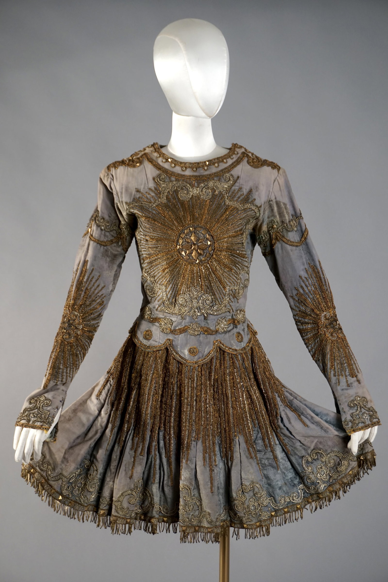 Antique Metal Embroidered Sunburst Dress, Early 18th/19th Textile Wardrobe: An exceptional European ceremonial or theatrical costume, constructed from blue velvet with elaborate ecclesiastical embellishments. The dress features rich gold bullion embroidery, metallic sequins, 
