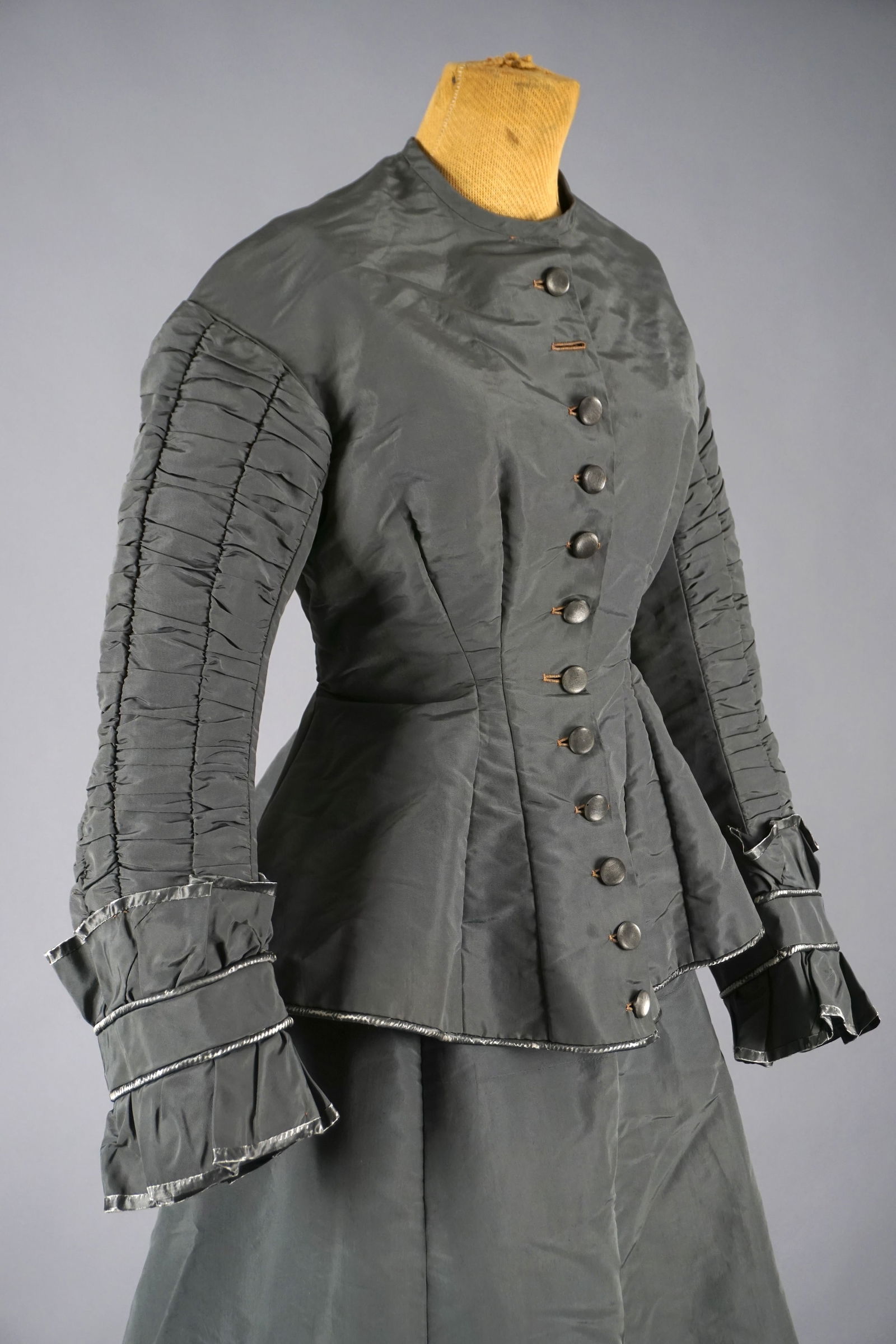1870s French Gray Silk Bodice Dress Ensemble by Mme. Eyroux, Montpellier: A French ensemble dating to the early bustle era (circa 1870–1880), this two-piece outfit comprises a steel-gray silk bodice and matching skirt, both exquisitely tailored. Labeled Mme. Eyroux – Ro