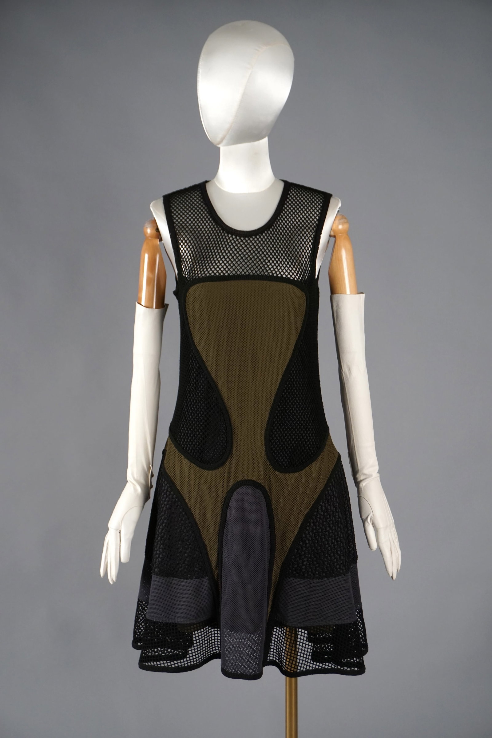 Avant-Garde Mesh Sport Dress by Ohne Titel, New York: A contemporary dress by Ohne Titel, known for their conceptual, futuristic womenswear. Constructed of layered cotton and nylon mesh, this sleeveless dress features sculptural paneling in olive, grey, 