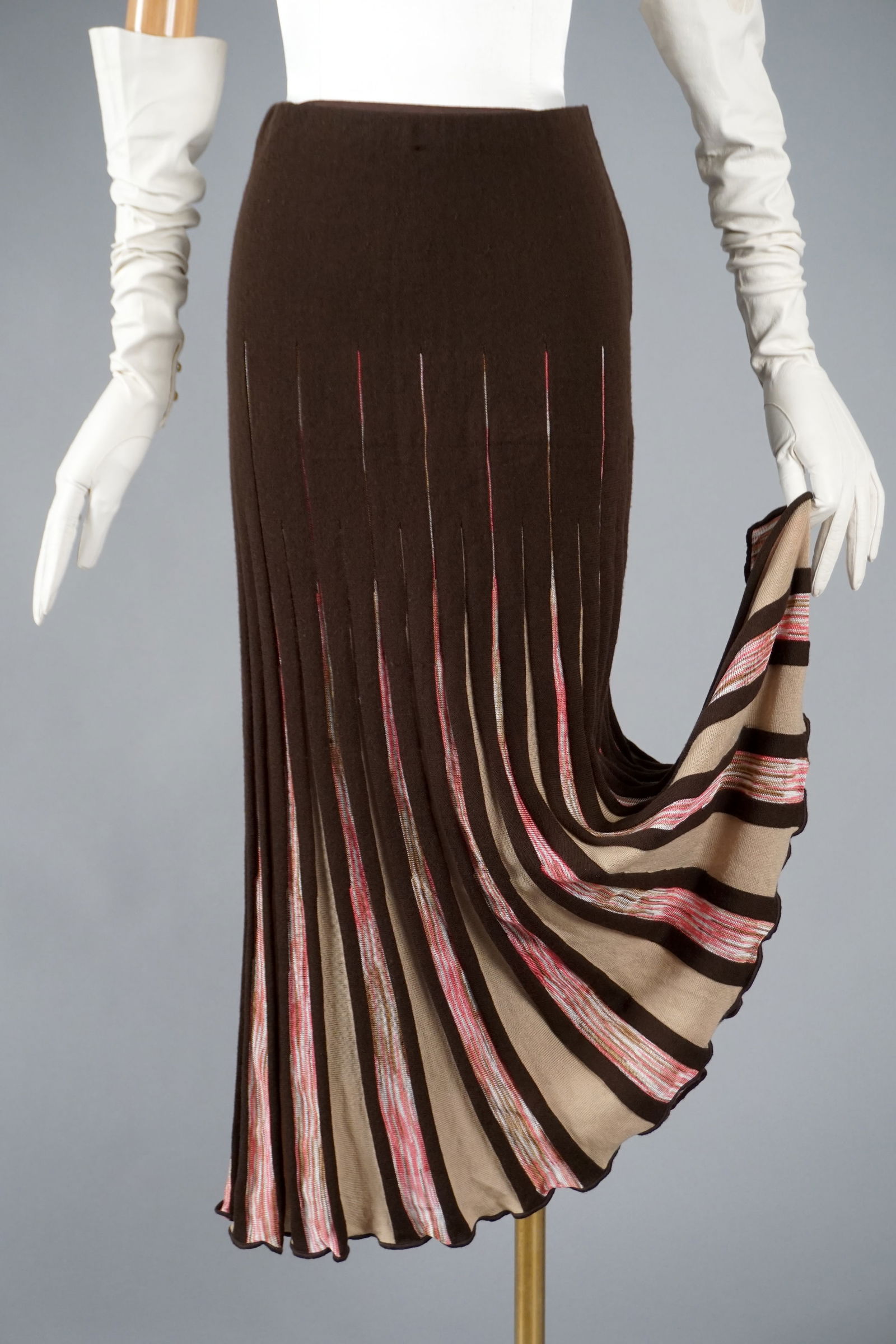 Missoni Pleated Knit Skirt, Made in Italy, Brown with Pink Pleats: A Missoni pleated skirt in chocolate brown with dynamic vertical striping in pink, champagne, and metallic shimmer threads. The classic A-line silhouette sways beautifully with movement, a hallmark of