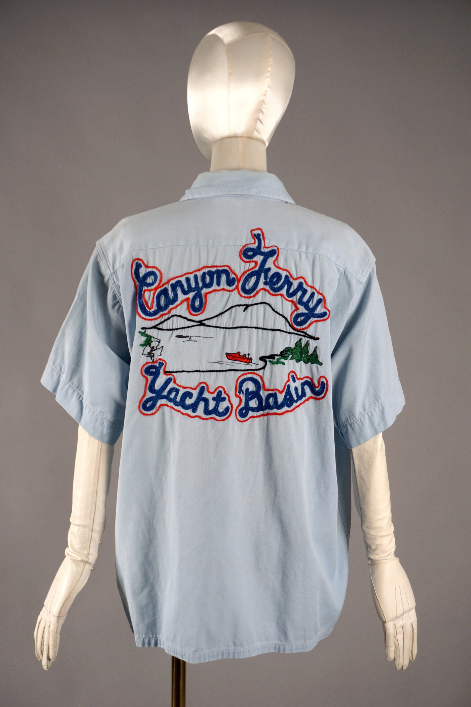 1950s Men’s Chainstitch Embroidered Shirt, Brill Bros Timberline, Montana, “Canyon Ferry Yacht: A 1950s chainstitch work shirt celebrating the Canyon Ferry Yacht Basin in Montana, beautifully embroidered with a mountain lake scene, pine trees, and a bright red speedboat across the back. The bold