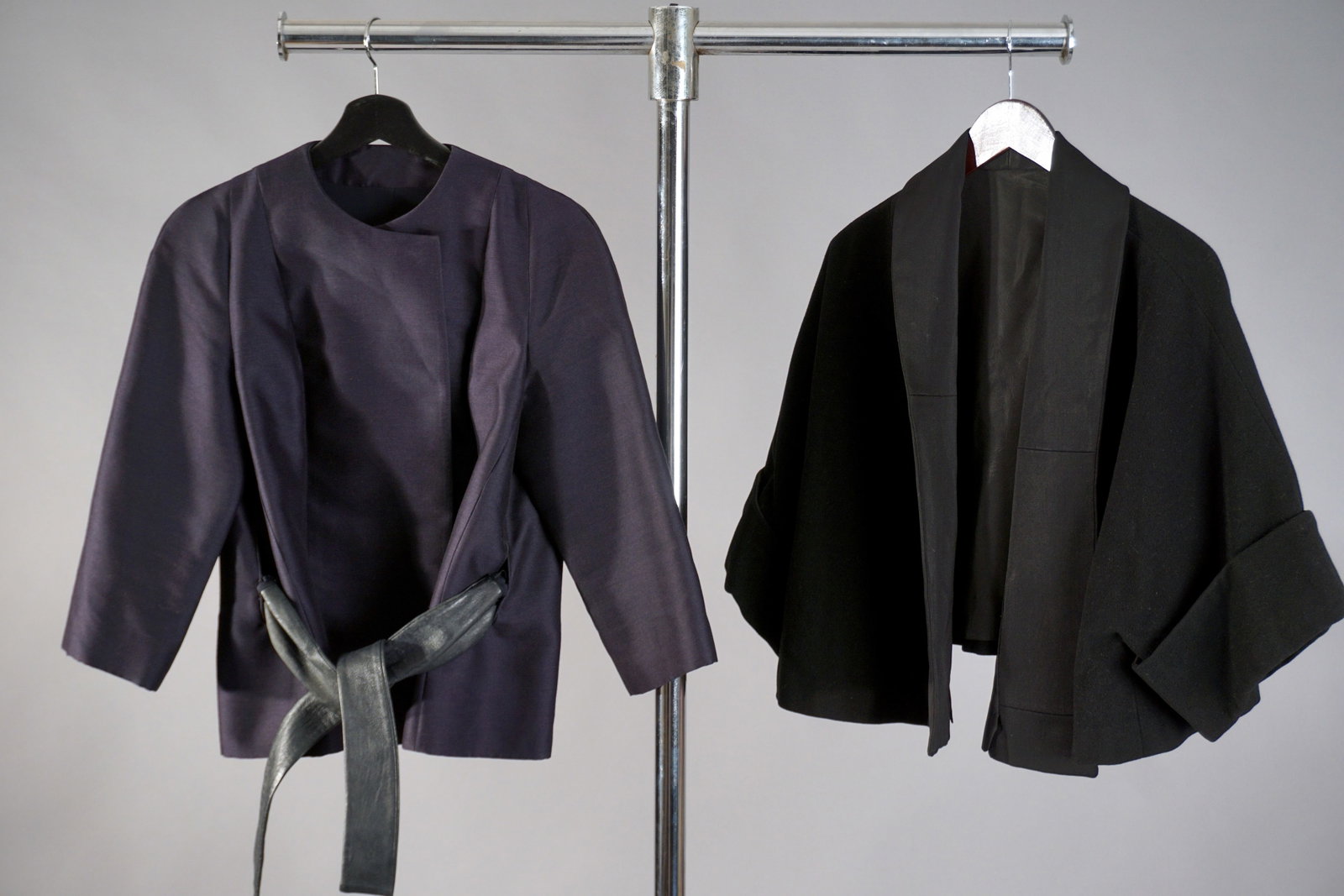 Lot of Two Vintage Jackets – Baffa Originals Belted Wrap & Minimalist Cropped Jacket: A stylish pairing of structured vintage outerwear, this lot features a belted jacket by Baffa Originals alongside a minimalist cropped piece in black. The Baffa jacket is rendered in a rich navy with 