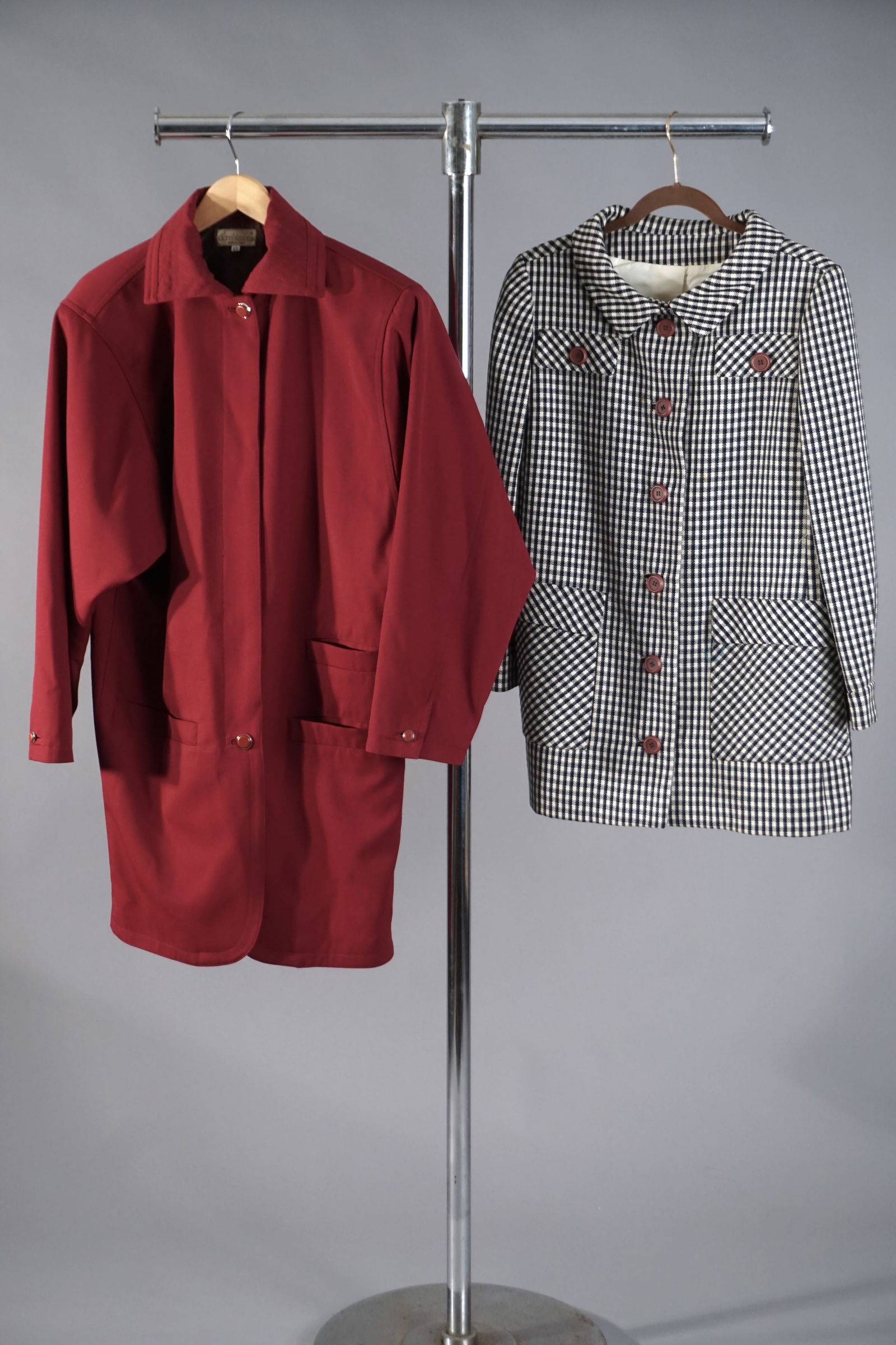 Lot of Two Vintage Designer Jackets – Gianni Versace Red Coat & Ginala Houndstooth Jacket: Gianni Versace Red Jacket – Labeled size 42, made in Italy. Pink crimson coat features a quilted collar, tonal jacquard satin lining woven with signature medallion motifs. Ginala Houndstooth mod Jac