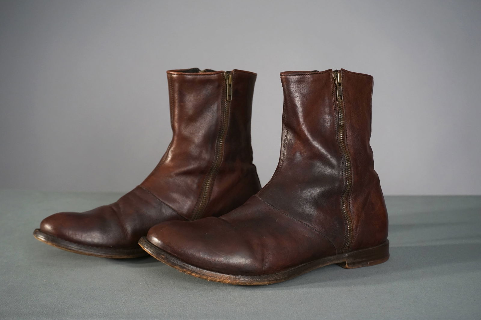 Alexander McQueen Men’s Brown Leather Side Zip Boots, Size 41: A pair of men’s ankle boots by Alexander McQueen, crafted in supple dark brown leather with a rounded toe and side zippers on both the inner and outer ankle. Fully lined in leather with a stamped si