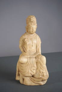 A Chinese White Marble Figure of Guanyin, Likely 19th Century or Earlier: Carved from white marble, this figure depicts the bodhisattva Guanyin seated in royal ease posture (lalitasana), one leg pendant and resting on a lotus-form base. Guanyin is presented wearing flowing