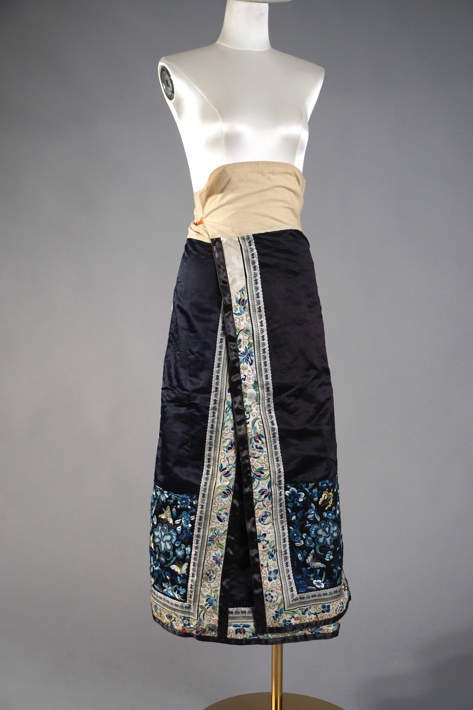 Antique Chinese Silk Embroidered Court Skirt: Antique 19th century blue ground Chinese silk embroidered skirt with floral and butterfly motifs. Linen waist. Size small, wrap style.