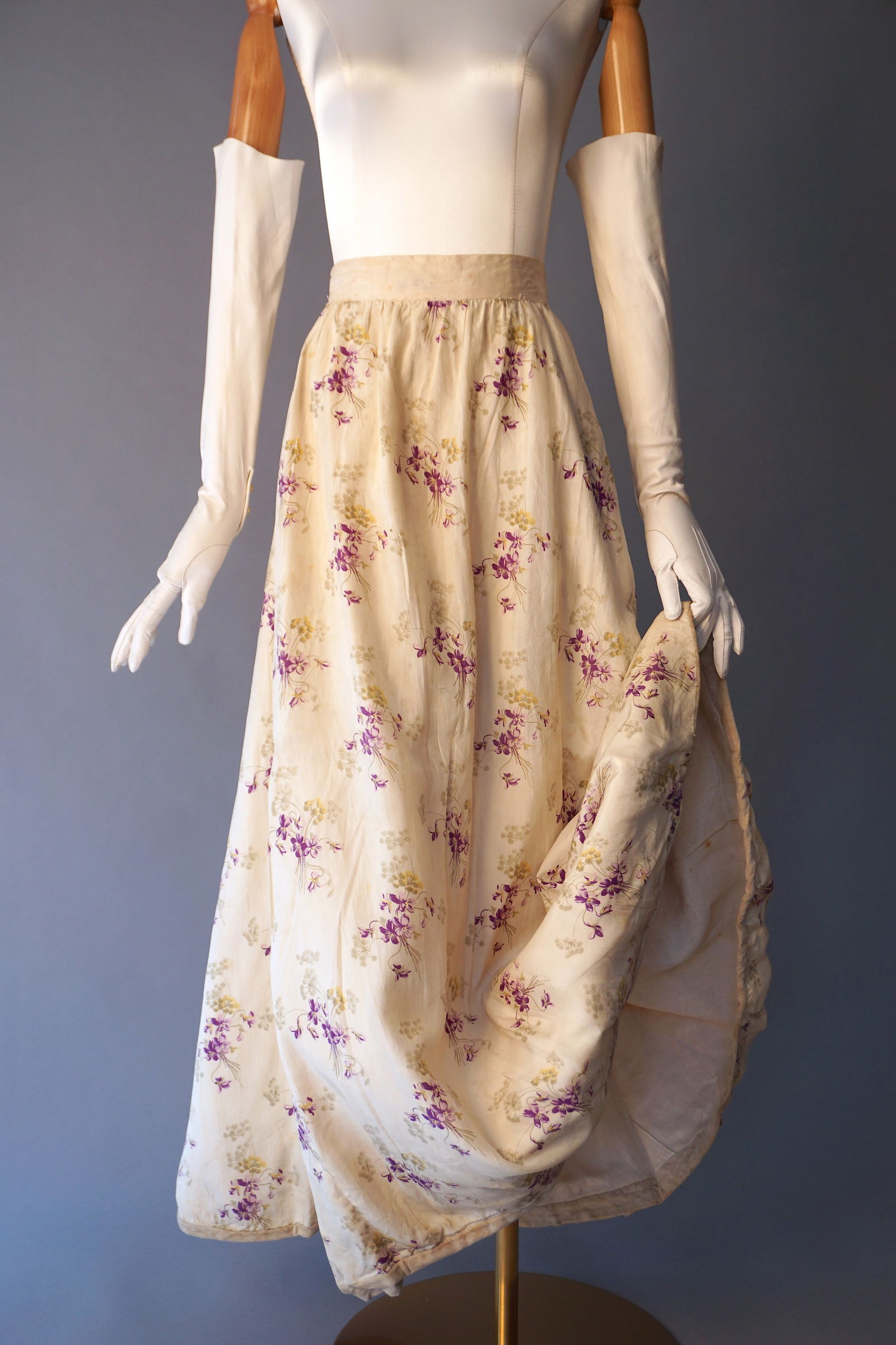 19th Victorian Silk Skirt with Violet and Wildflower Bouquets: 19th century off white silk skirt patterned with delicate violet and yellow floral sprays, fully lined in a sturdy muslin or linen. Designed with a softly gathered waist and flowing A-line silhouette.