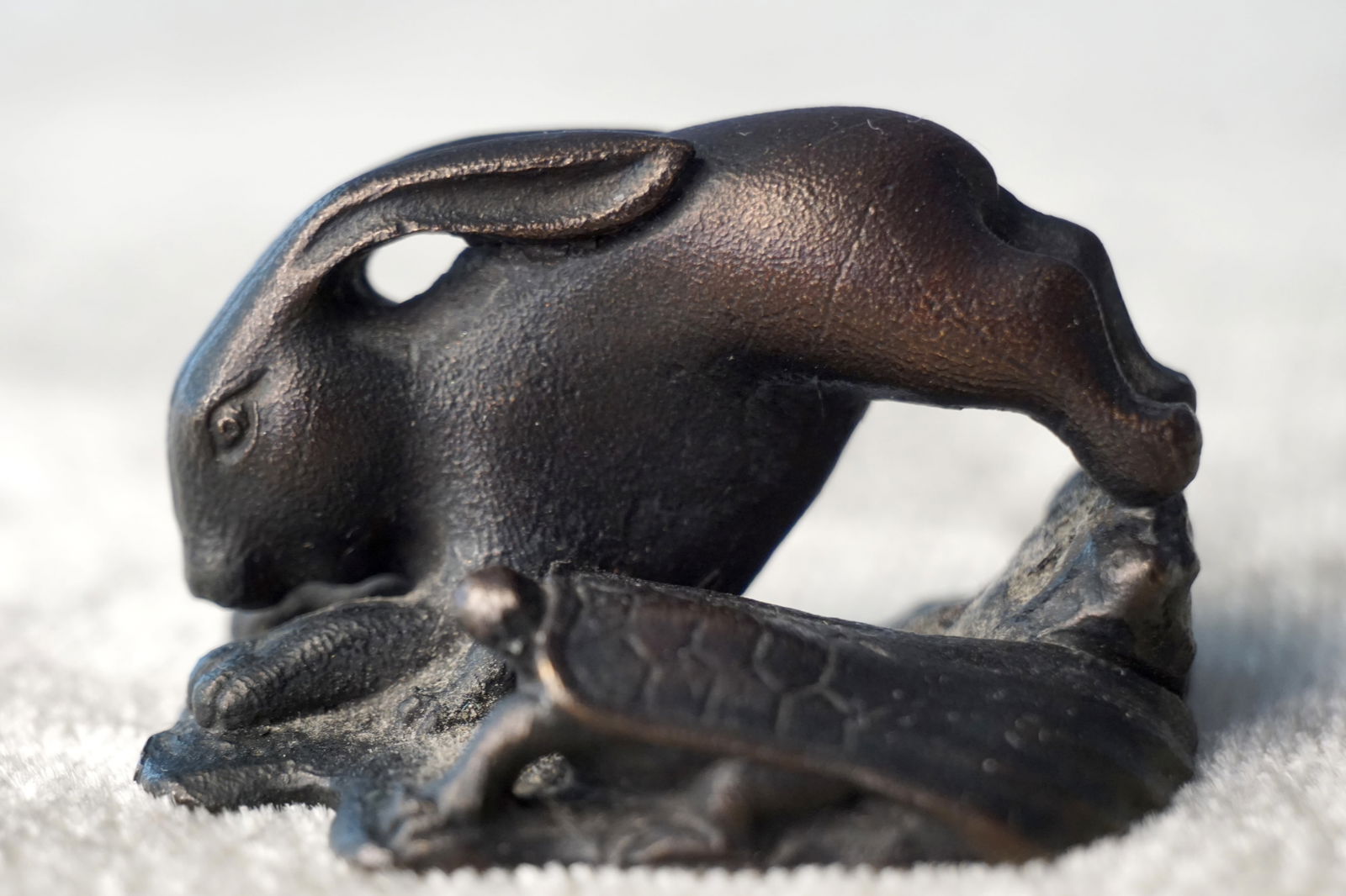 A SIGNED BRONZE NETSUKE OF A RABBIT AND TORTOISE (1 of 7)