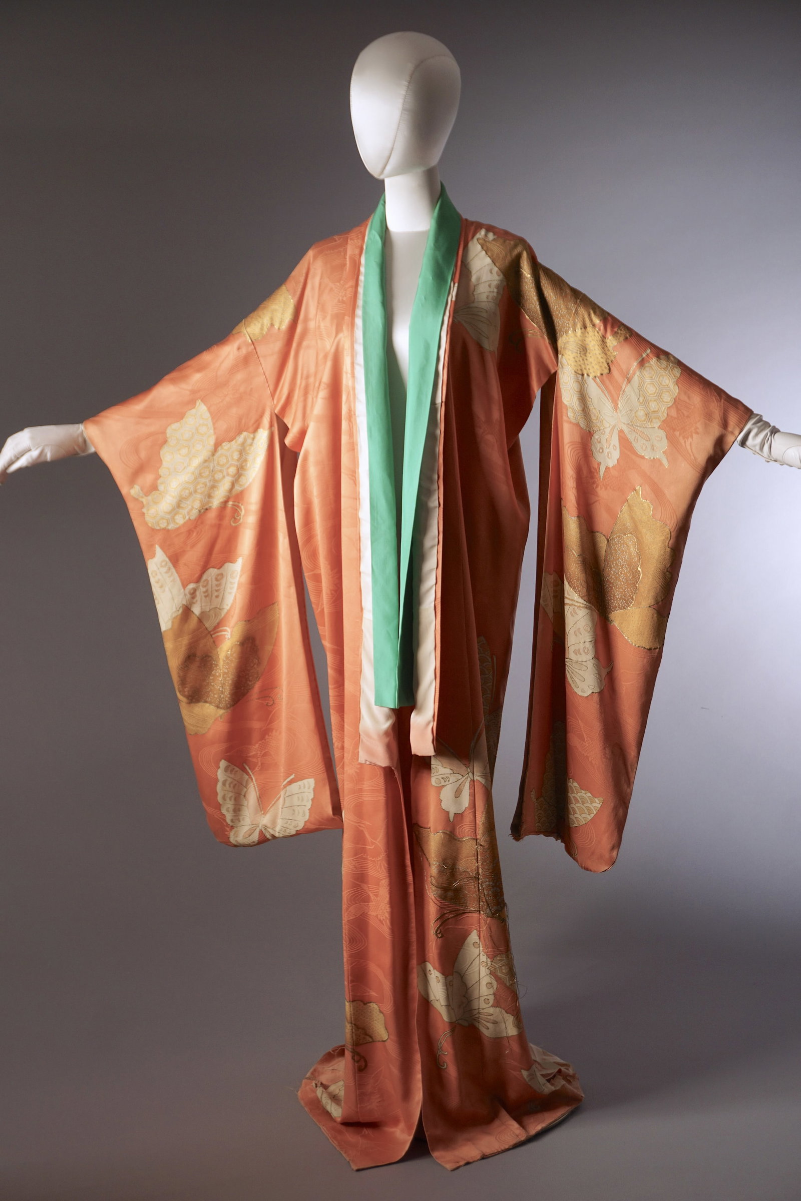 Vintage 1920s 30s Pink Silk Kimono with Butterfly Motifs: Vintage early 20th Japanese silk kimono in a soft blush pink tone (appearing more orange under studio lighting). The textile is a silk with a flowing jacquard ground, decorated throughout with large s