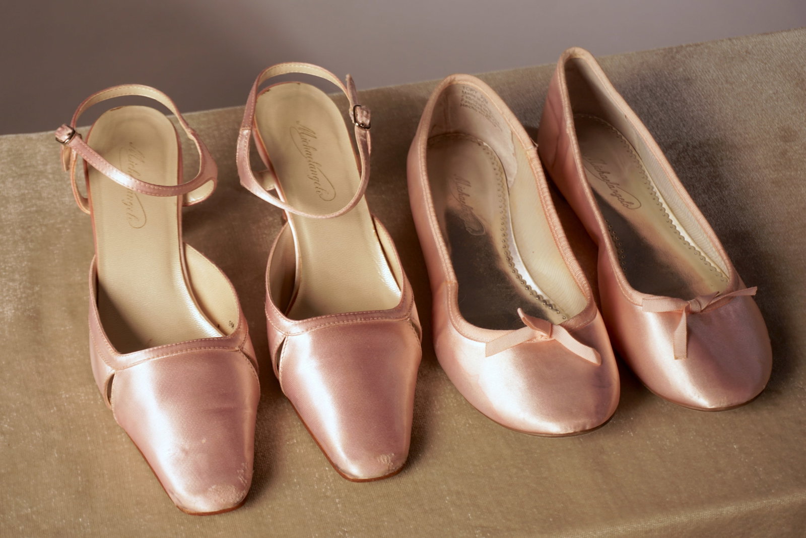 Group Of Two Pink Satin Shoes, Michelangelo Flats Size 9.5 And Heels Size 9: A coordinated pair of blush pink satin shoes by Michelangelo: one set of ballet flats in size 9.5 and one pair of slingback heels in size 9. Provenance: from the atelier assemblage of Adrián Villeta,