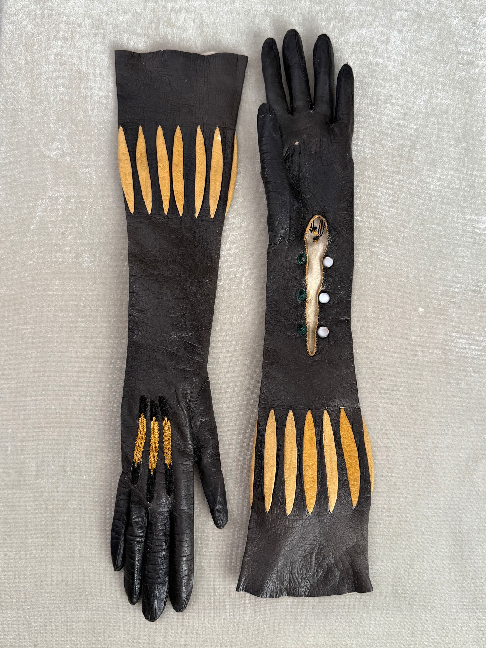 Antique Victorian Opera Cage Gloves with Yellow Accordion Insets & Pearl Buttons: Unusual late 19th century Victorian opera length cage gloves in black leather, size 6- 6.5 (very small) Designed in an uncommon accordion/ cage style with yellow leather inset panels and decorative ha