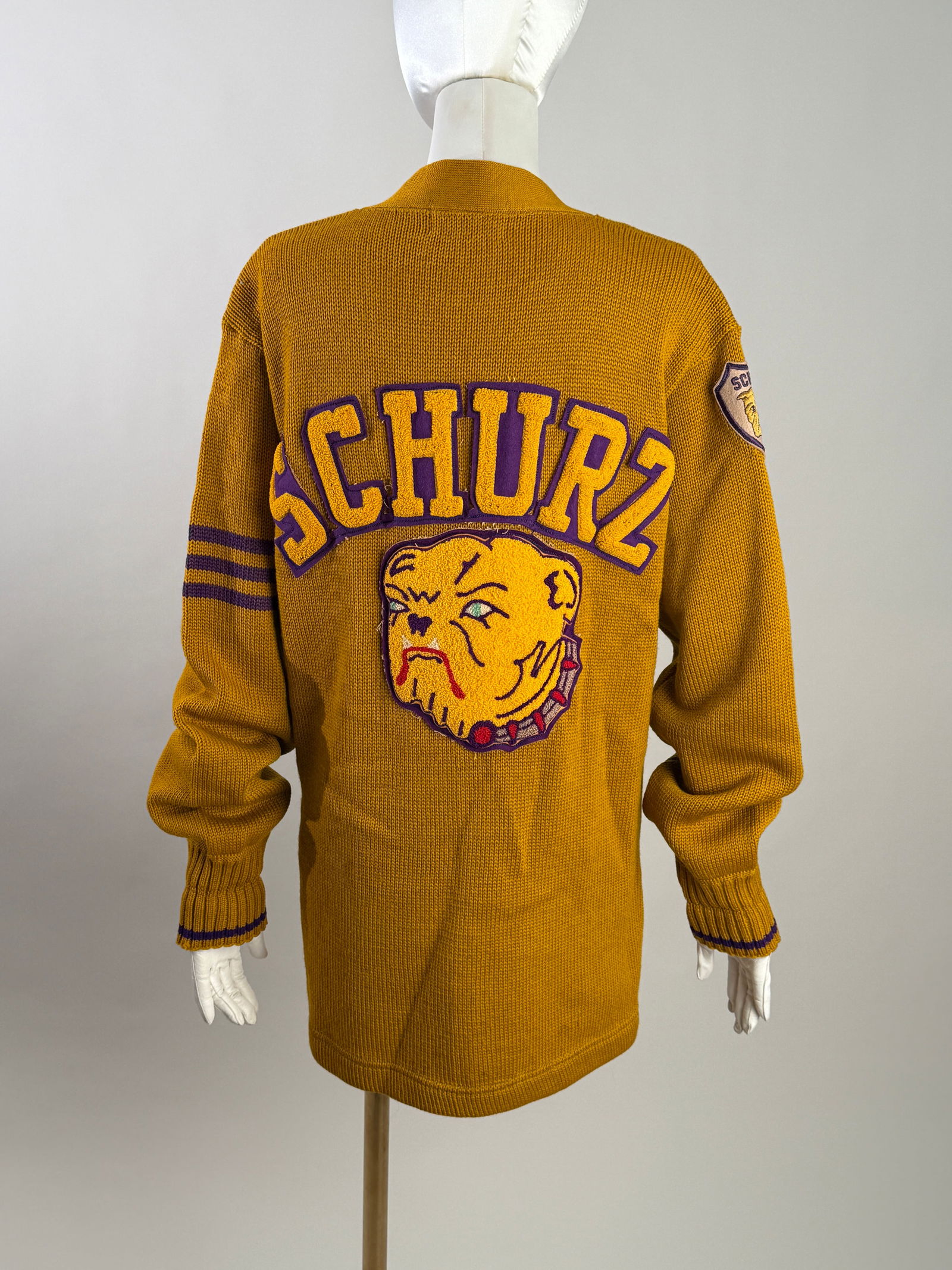 Vintage 1940s 50s Schurz Chicago Wool Letterman Cardigan Bulldog Chenille Patch: Vintage Schurz High School letterman cardigan in bold gold wool with purple trim. This vintage piece features large “SCHURZ” chenille lettering across the back with an oversized bulldog mascot