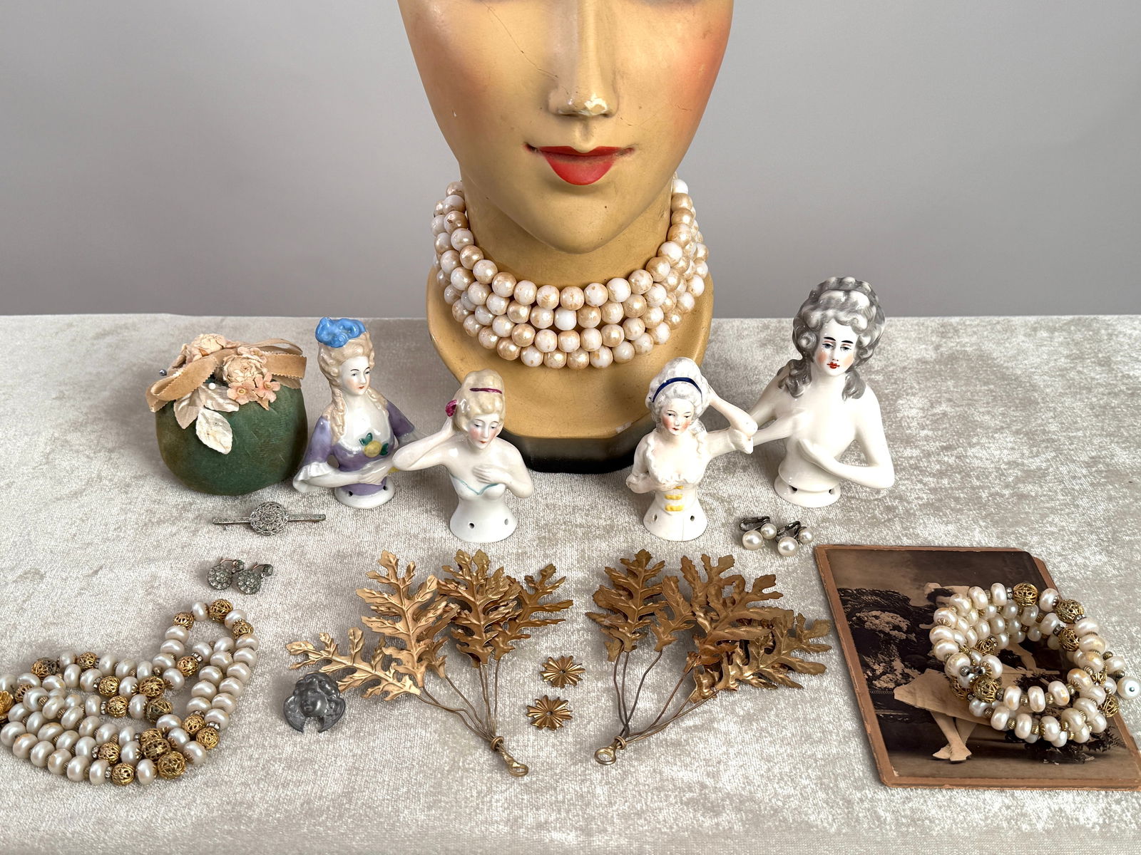 Antique Porcelain Half Doll Group, Gilt Hair Ornaments, Costume Jewelry: Assorted antique and vintage decorative group including four German porcelain half dolls (brush or dresser dolls), two gilt metal leaf form hair or decorative ornaments, an assortment of costume jewel