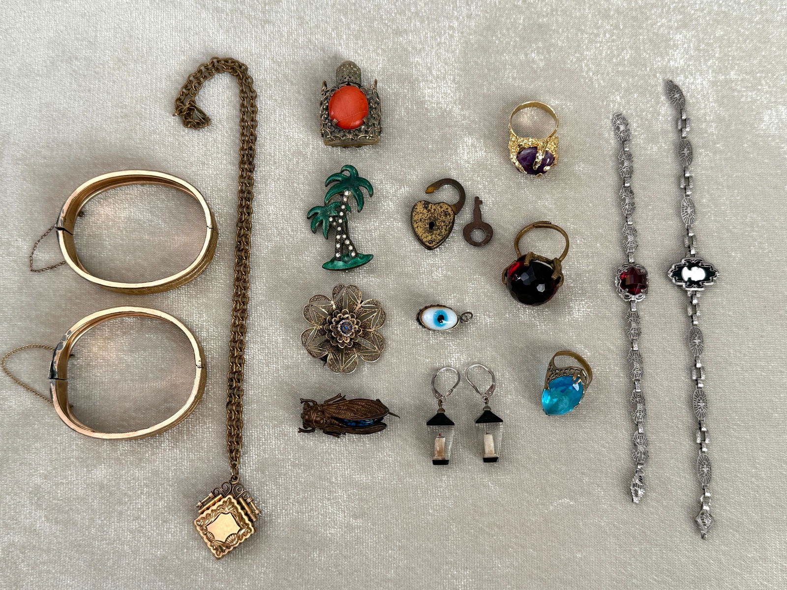 Group of 15 Antique & Vintage Costume Jewelry Pieces: An assorted collection of 15 antique and vintage costume jewelry pieces dating roughly from the early 20th century through mid century. The group includes three large statement rings with faceted glas