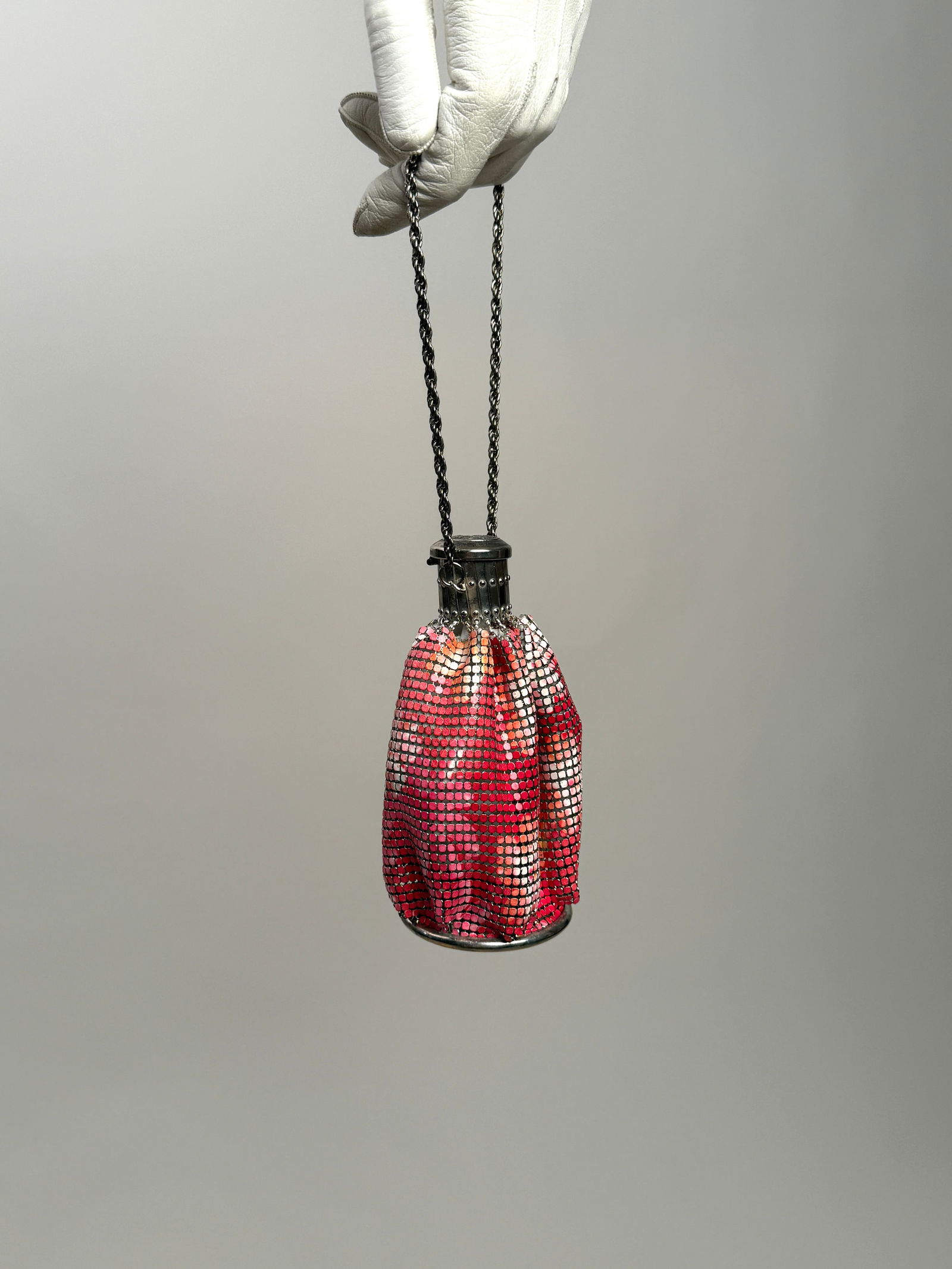 Vintage Pink Metal Mesh Expandable Purse w/ Mirror: Vintage metal mesh purse in a pink and coral palette, with expandable frame top and chain strap. The bag opens to a white lining and retains its original round compact mirror at the base. 5.5" x 4", 1