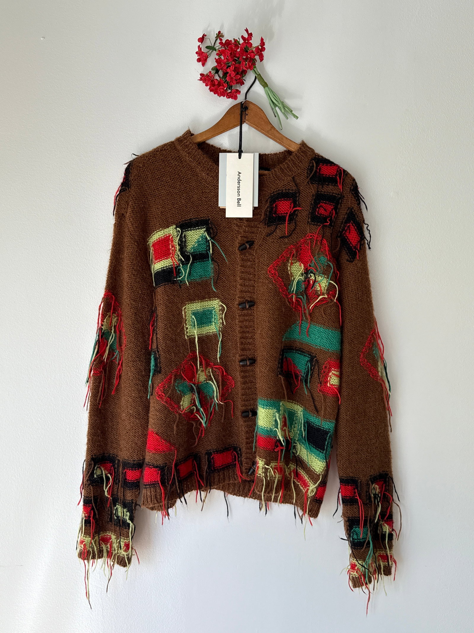 Andersson Bell FW23 Brown Mohair Blend Yarn Cardigan Sweater: Village Intarsia Cardigan by contemporary brand Andersson Bell which was released as part of their Fall/Winter 2023 collection. This piece is made from a fine mohair blended yarn and features a distin