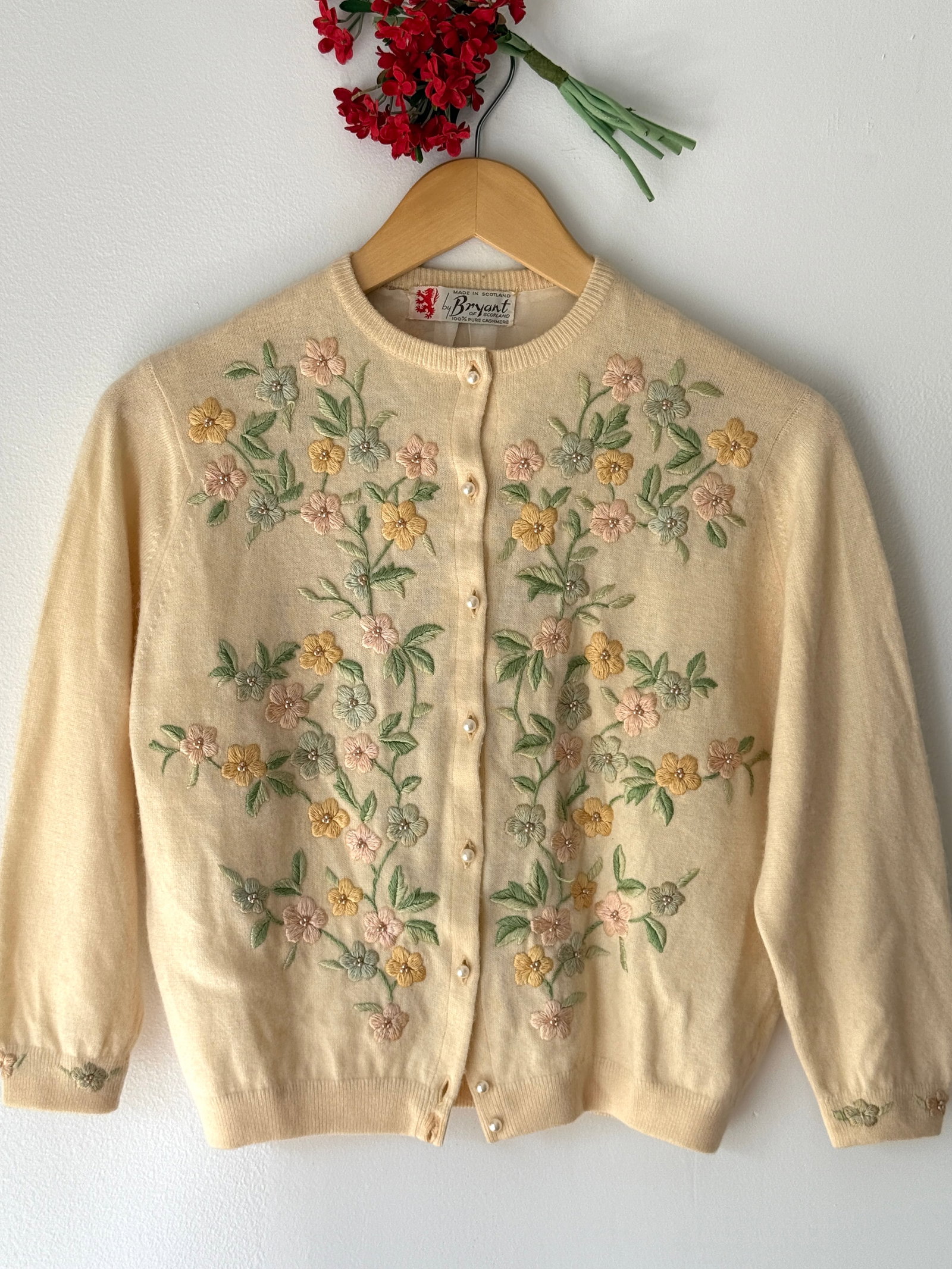 Vintage 50s Bryant of Scotland Embroidered Cashmere Cardigan Pastel Florals: Vintage mid century Bryant of Scotland cardigan 100% pure ivory cashmere and made in Scotland. The exterior features hand embroidered pastel floral motifs with seed beads and a full front closure with