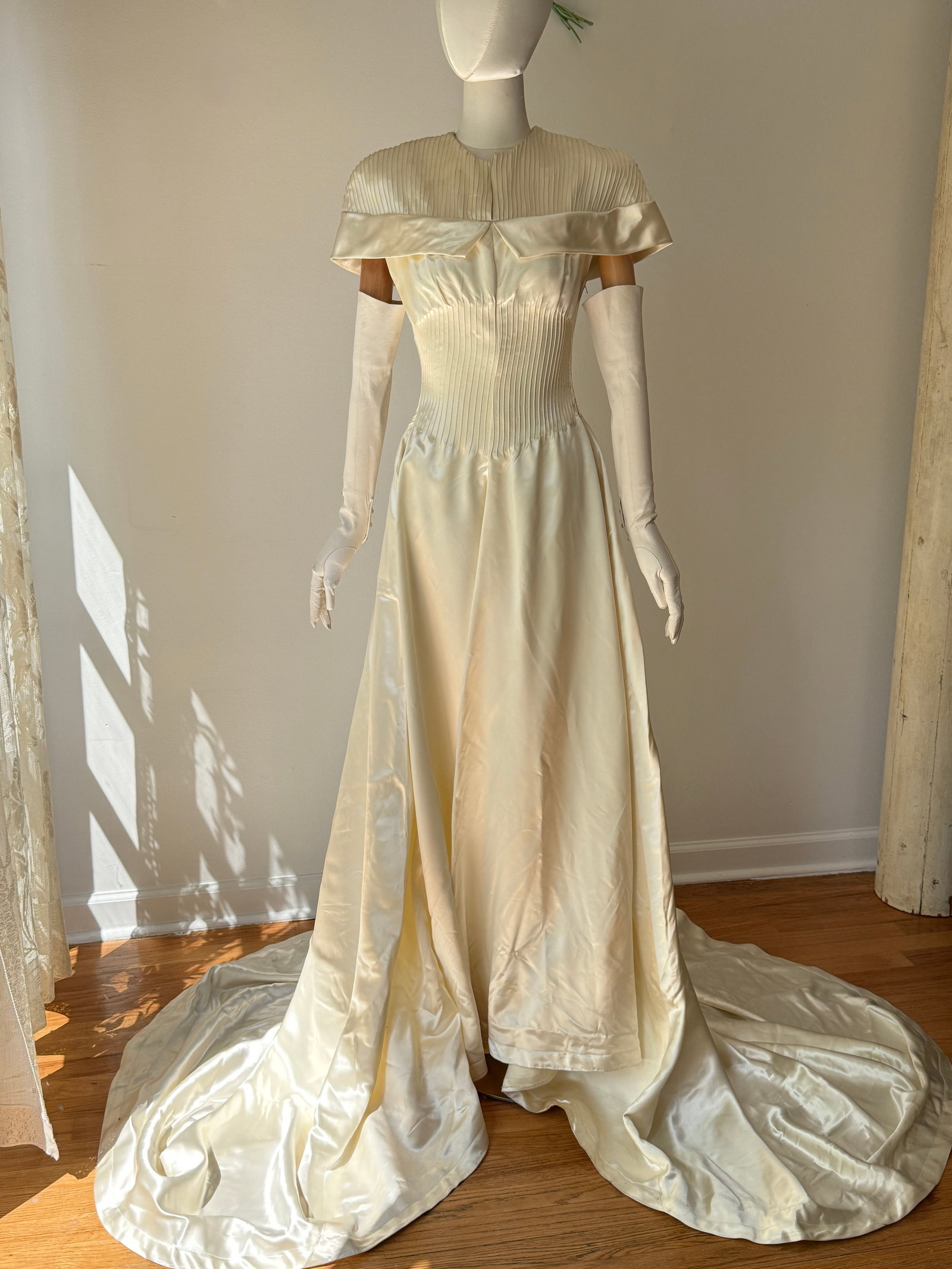 Vintage 1940s Old Hollywood Liquid Satin Wedding Gown with Pin Tuck Bodice: Vintage 1940s old Hollywood bridal gown made from ivory slipper rayon satin that offers a heavy, liquid like drape and a luminous sheen. The bodice features vertical pin tucking, tailored waist with m
