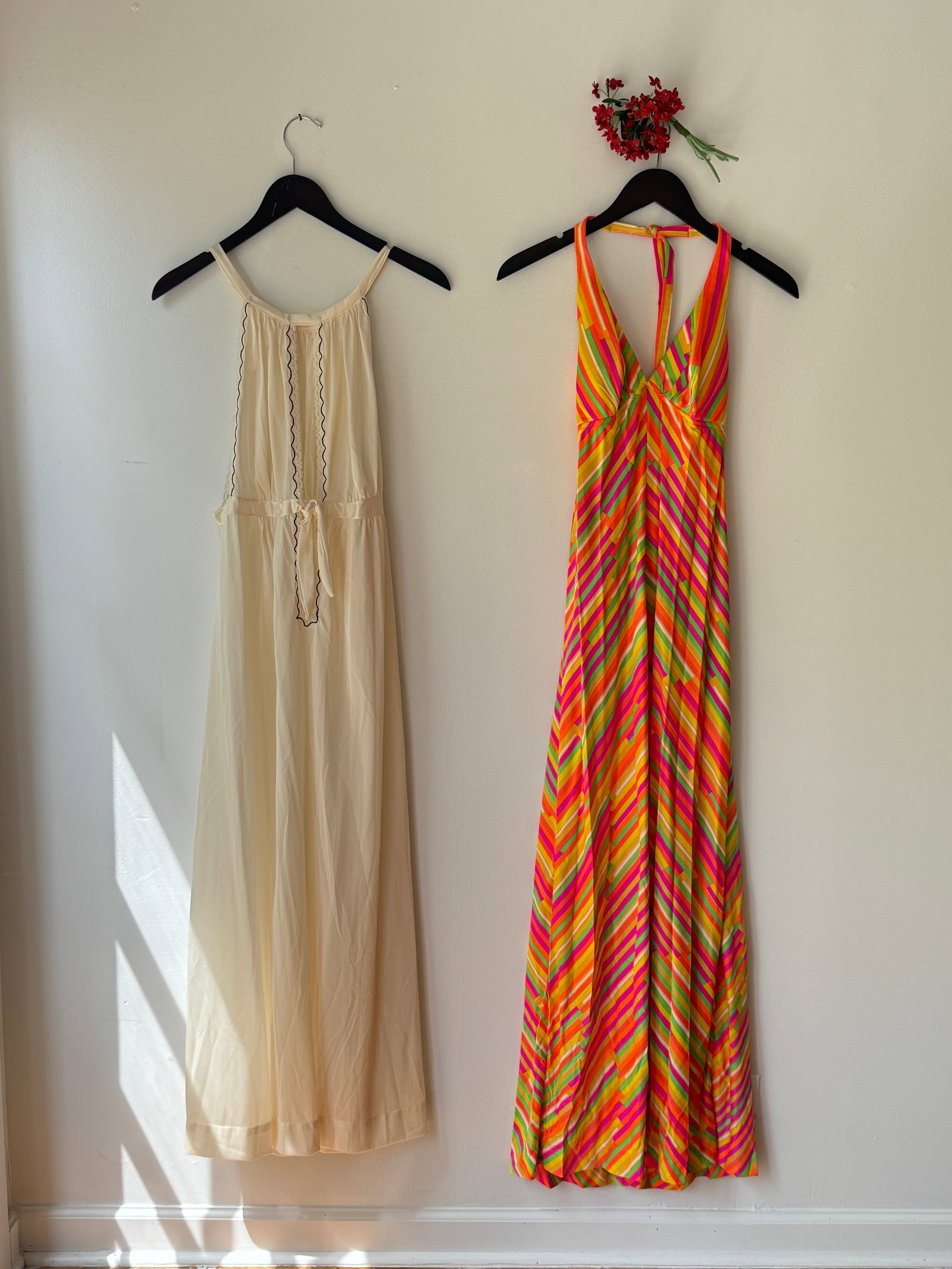 Lot of Two Vintage 1970s Dresses Including Catalina California Neon Maxi: Two vintage dresses from the 1970s- a neon striped maxi dress by the Catalina California, in palette of orange, pink, and yellow in a chevron style pattern. The second is an ivory negligee dress accen