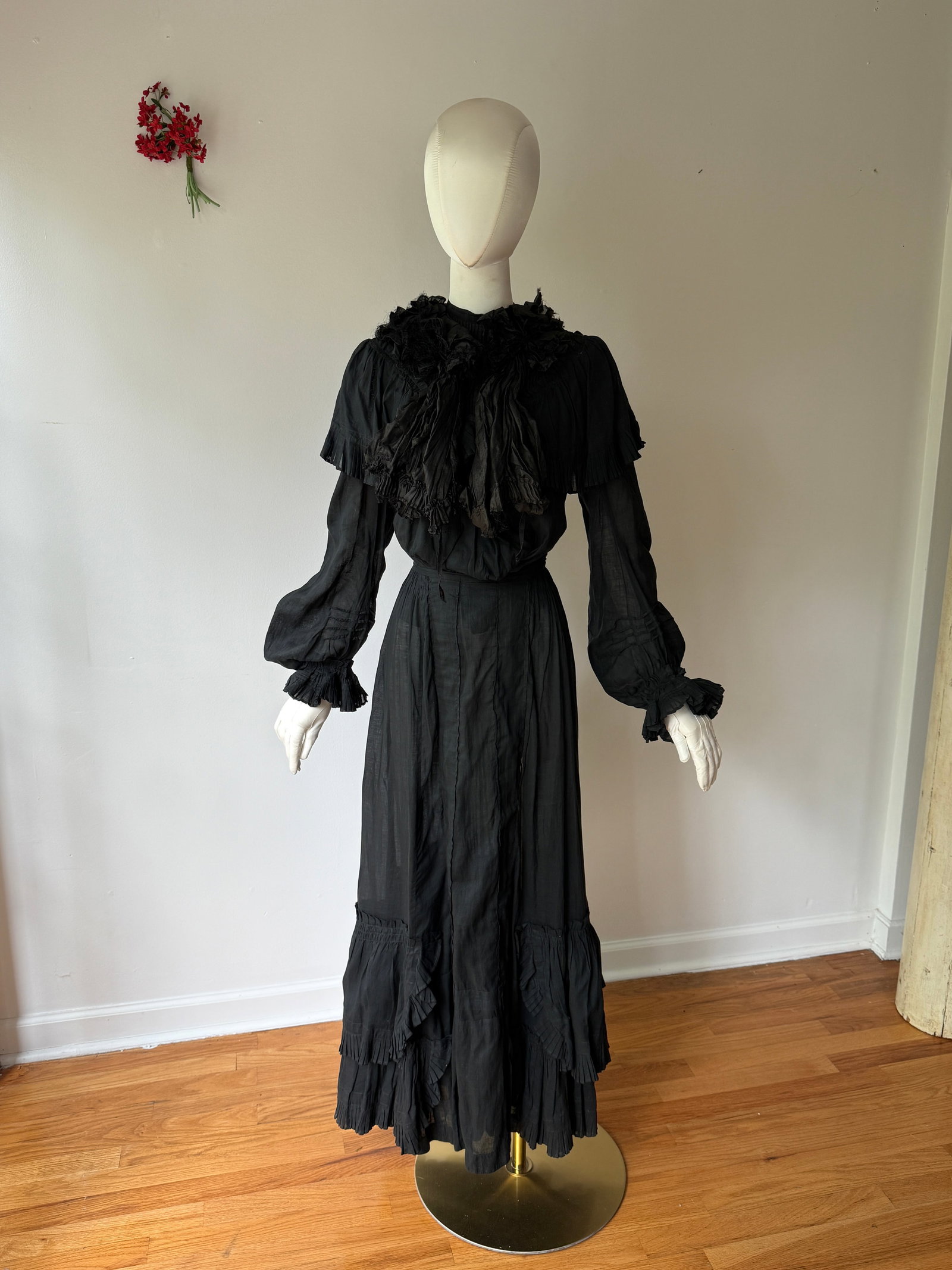 Antique Victorian Gothic Cotton Dress Ensemble & Silk Ruffle Collar: Antique two piece Victorian ensemble in semi sheer black cotton, tiered ruffled skirt and a matching long sleeved and pleated puff sleeved bodice. Comes along a silky ruffle collar. Measurements: 32&r