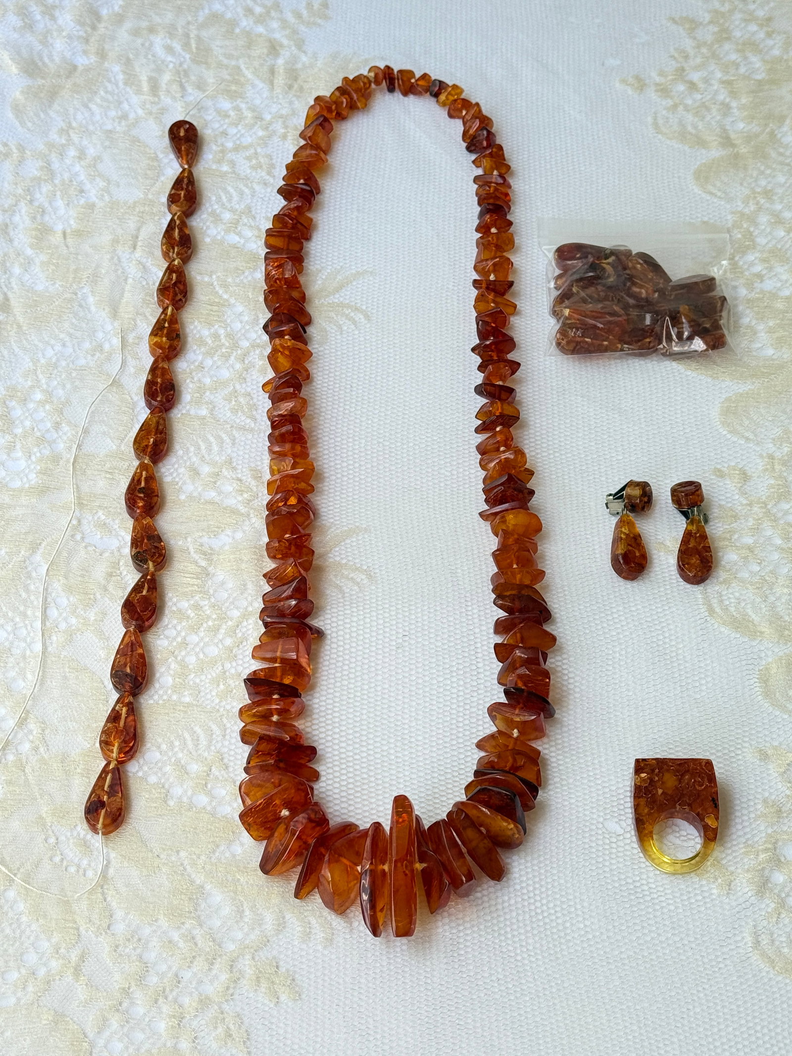 Antique Vintage Baltic Amber Necklace Jewelry Collection: Vintage jewelry group with a large graduated nugget necklace crafted from polished cognac colored amber. The collection includes a matching pair of teardrop shaped dangle earrings and a chunky, geomet