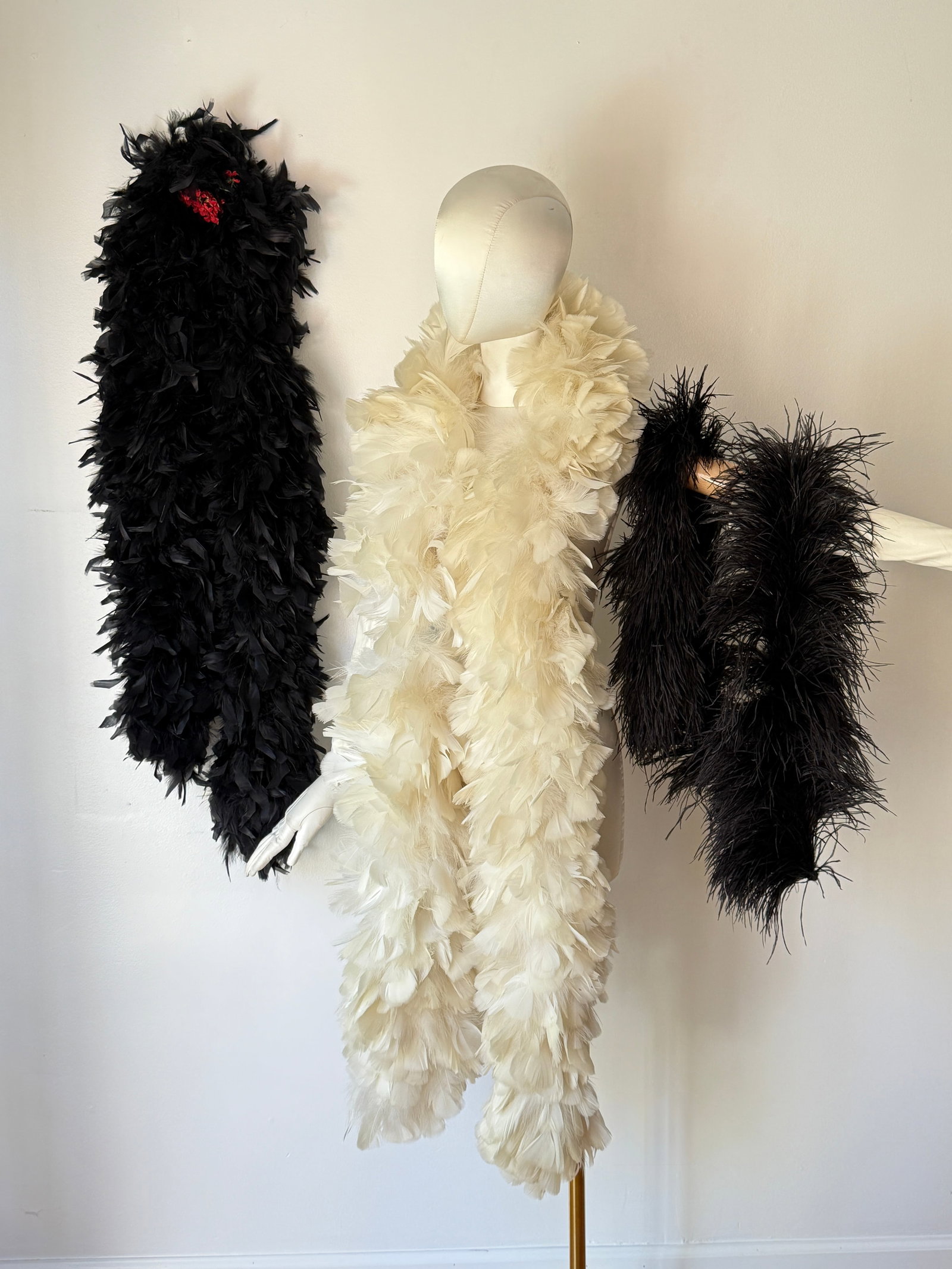 Vintage Feather Boa Group of Three, Vintage Showgirl Costume: Three vintage mid century feather boas in black and white, the group includes a voluminous white ostrich feather boa alongside two distinct black boas, one offering a thick, plush texture and the othe