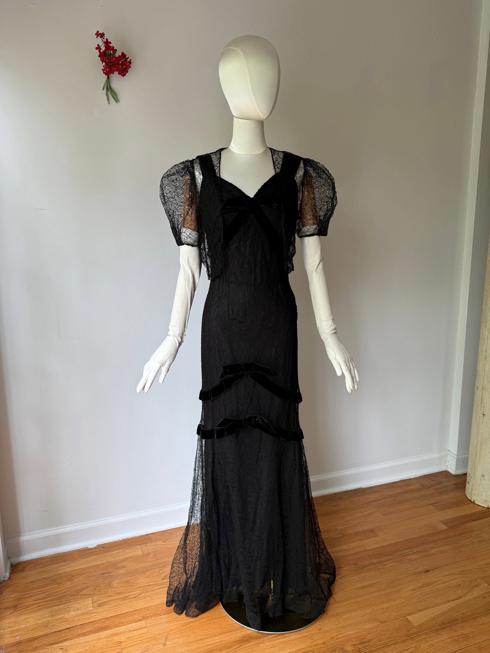 Vintage 1930s Black Lace and Velvet Bow Dress with Bolero: Two piece ensemble from the 1930s features a floor length dress in a black floral lace with matching bolero jacket. Bias cut with tiered velvet ribbons on the bodice and skirt. Metal side snap closure