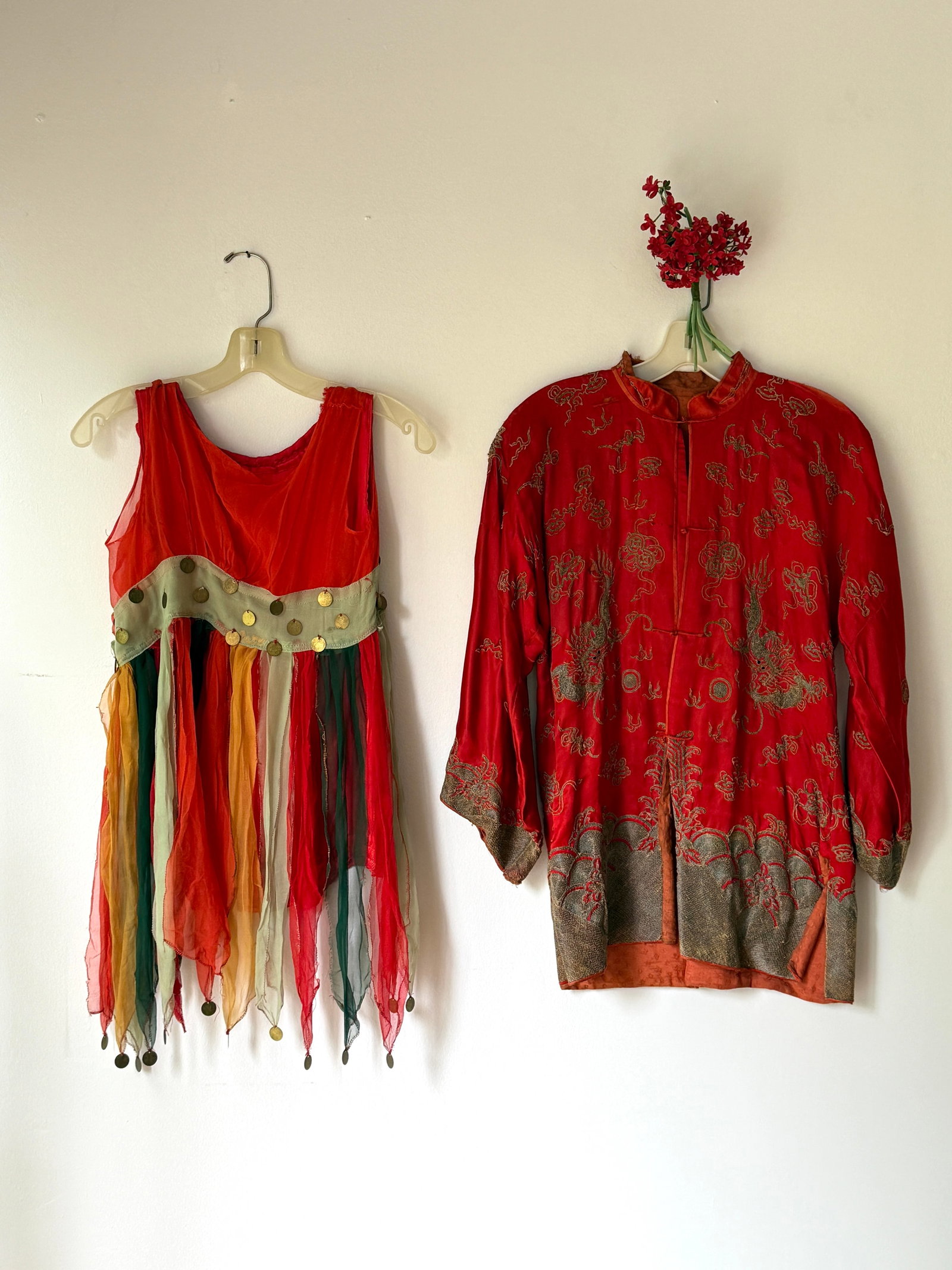 Antique Chinese Red Silk Embroidered Dragon Robe & Youth Chiffon Costume Group: Lot of two vibrant antique youth sized garments. A red silk Chinese robe intricately hand embroidered with gold metallic threads, featuring traditional dragon and longevity Shou motifs. The robe inclu