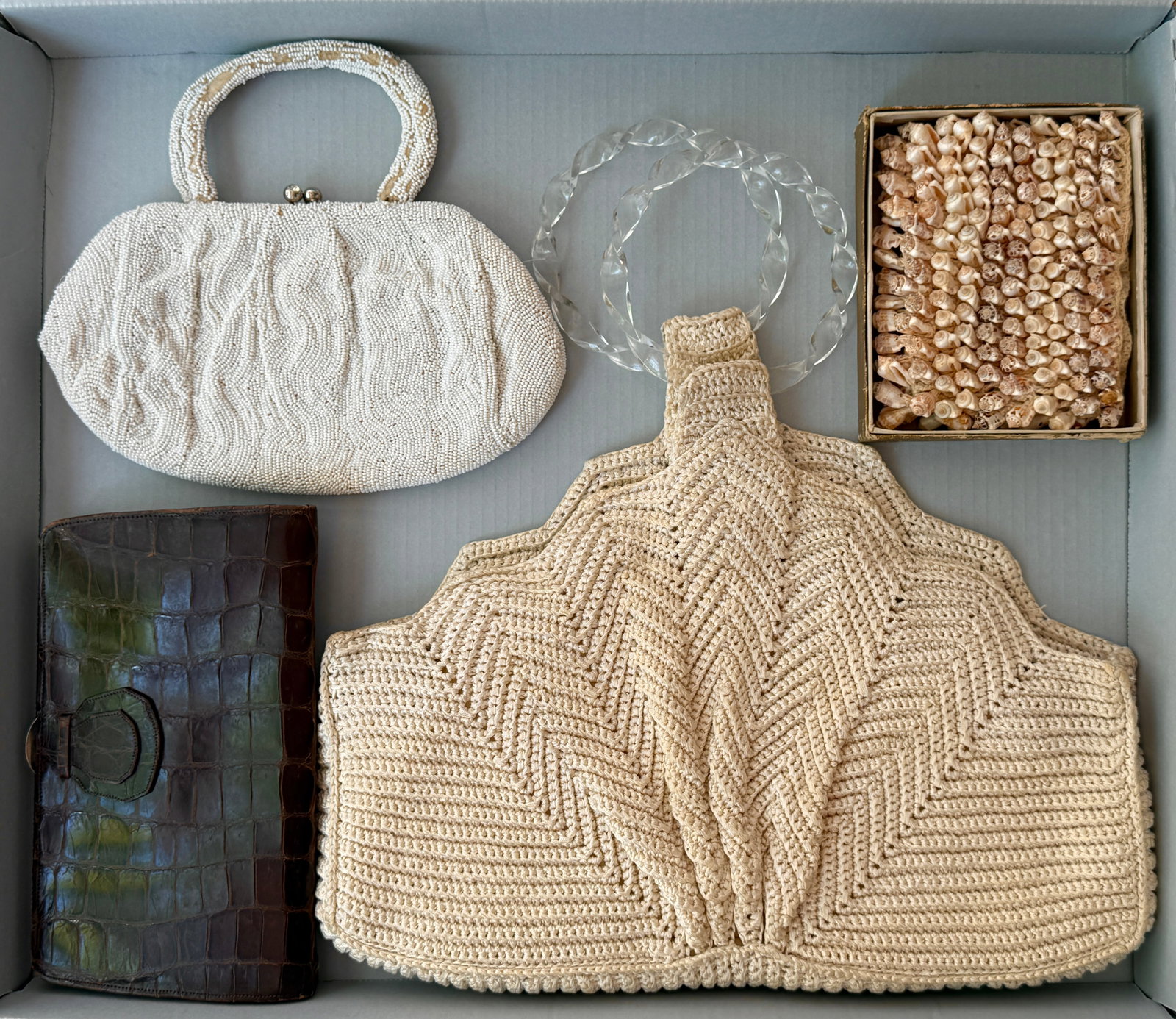 Vintage 1940s 50s Purse Handbags Group of Four: Vintage mid century handbag group of four. An oversized fan like seashell crochet or macramé purse with lucite handles, a 50s white seed bead purse, a brown embossed crocodile leather clutch and a sm