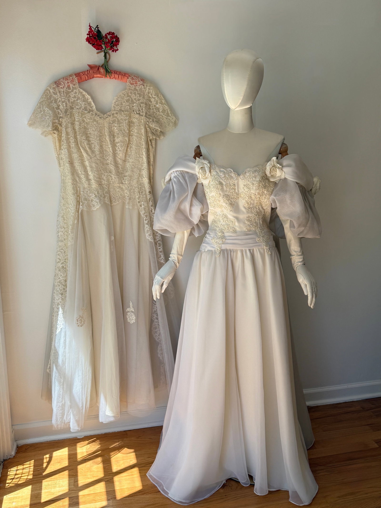 Lot of Two Vintage Bridal Gowns: Mid Century Lace & 1980s Puff Sleeve Dress: This lot features two eras of vintage bridal fashion. The first is a mid century gown with a delicate lace overlay, short sleeves, a scalloped V neckline, and a layered tulle and chiffon skirt. The se