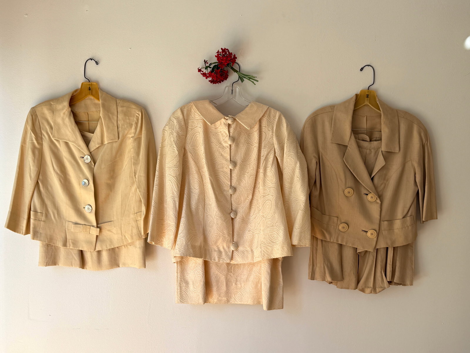 Lot of Three MCM Vintage Silk Skirt Suits Neiman Marcus: Group of three vintage women’s skirt suits in cream and tan silks and cotton- a 1940s 50s tan gabardine two piece ensemble with a notched lapel jacket with mother of pearl buttons and coordinating s