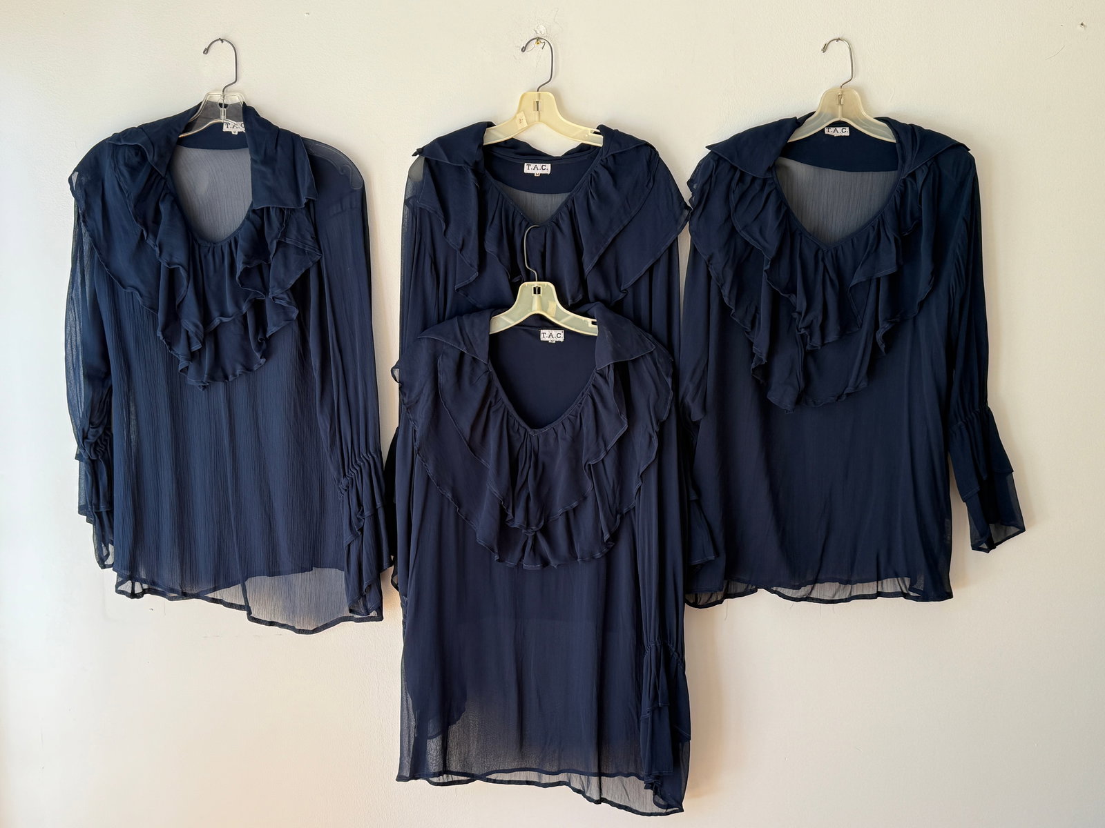 Lot of 4 Vintage Navy Blue Sheer Ruffle Front Poet Blouses: This lot includes four matching vintage theatrical navy blue blouses in semi sheer viscose chiffon Made in India. These poet tops feature multi layered ruffles cascading down the front and are designe