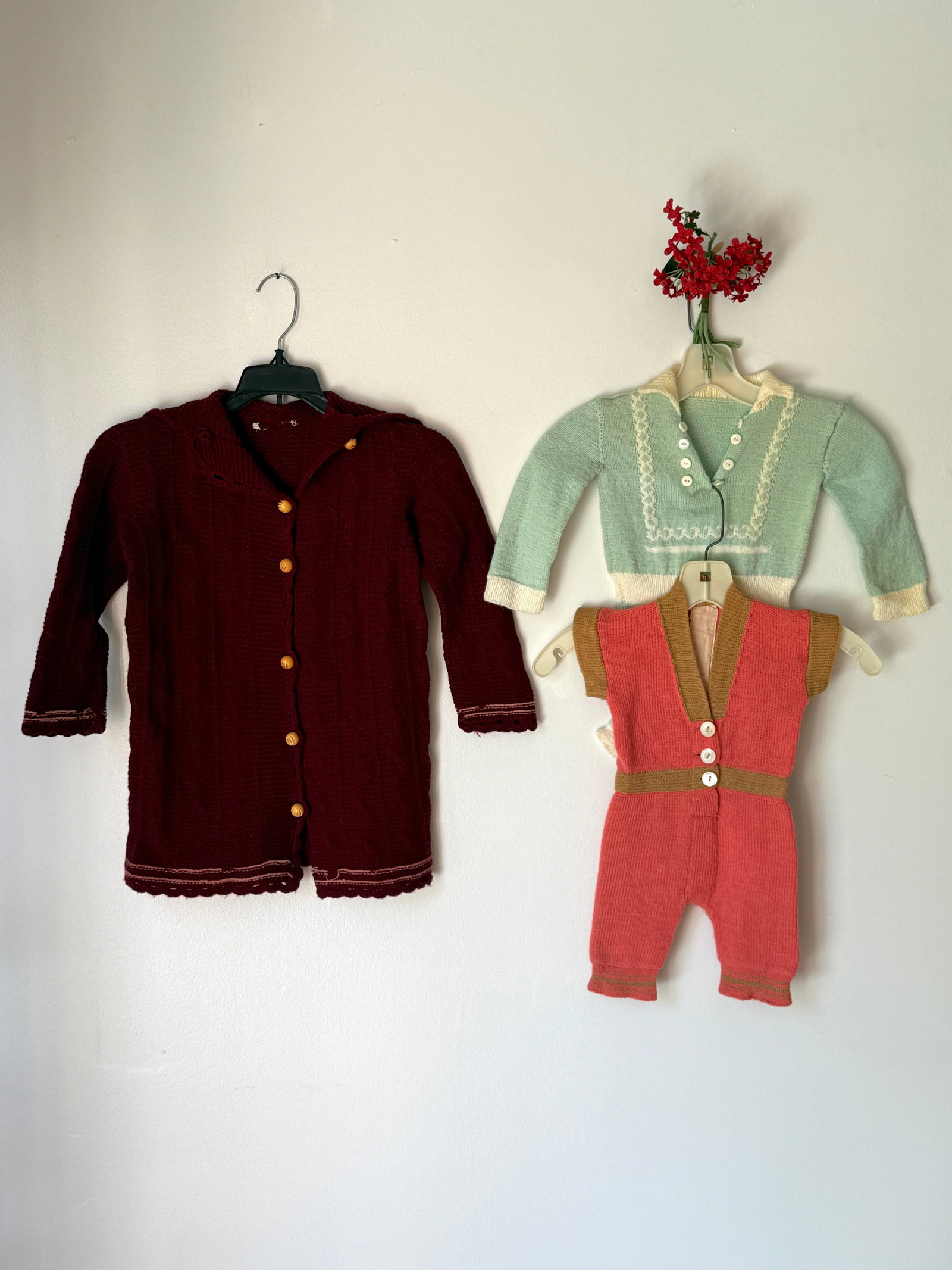 Antique Vintage Knitted Children’s Clothing Lot & 30s Bakelite Button Wool Kids Sweater: Antique/ vintage children’s clothing lot features three knitted garments. A mint green long sleeved Cradleknit jumper bodysuit with cream colored ribbed trim, a flat rounded collar, and decorative f