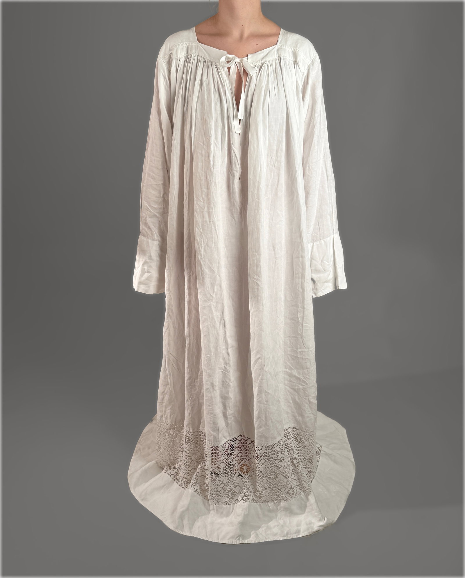 Antique White Cotton Clerical Priest Alb Dress with Openwork Lace: Antique liturgical garment featuring a full length, flowing priest alb or clerical dress in a lightweight white cotton fabric. The garment is designed with dense gathering along the square neckline, a