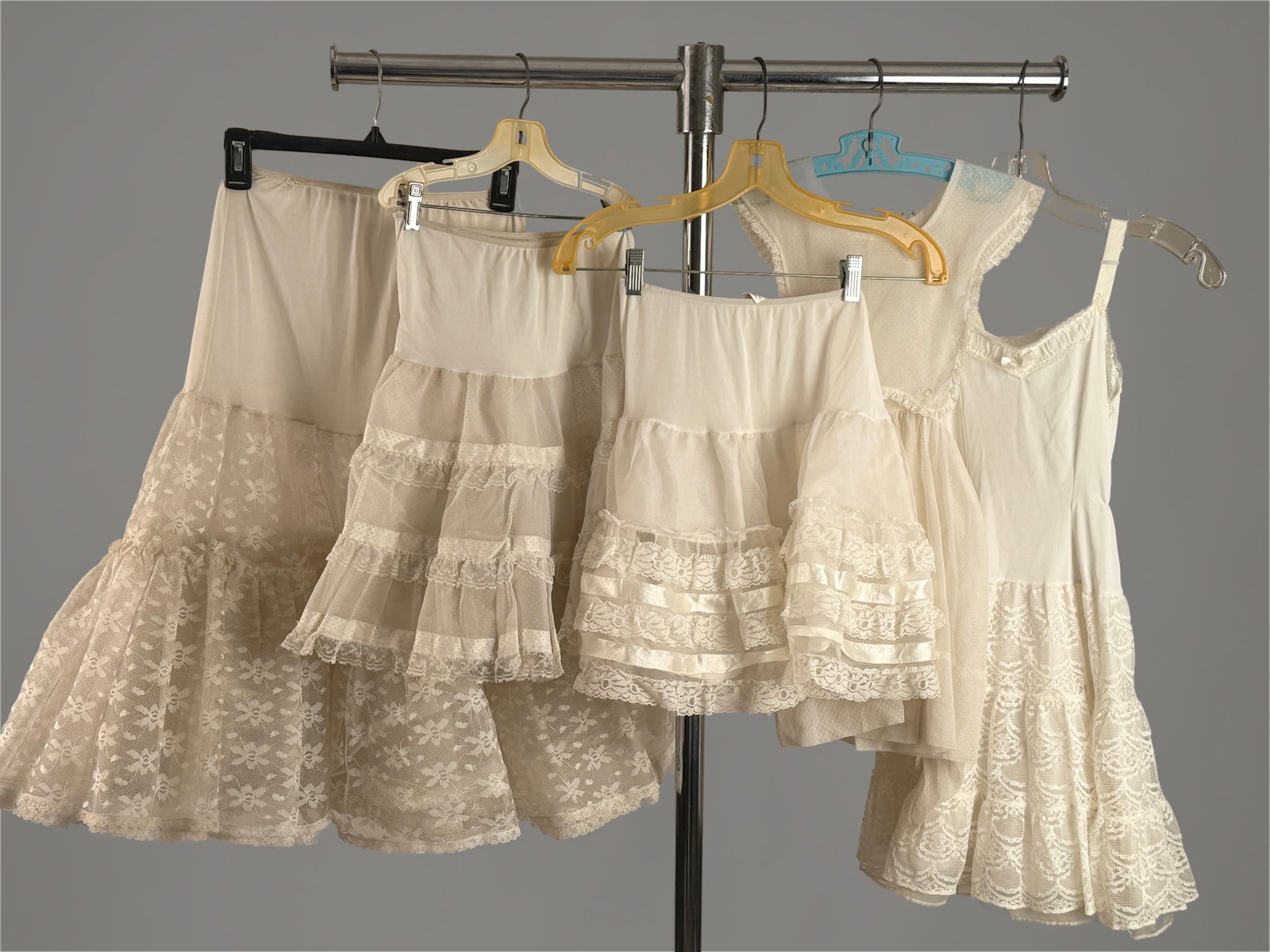 Group of Women's Vintage Lace Crinoline Petticoat Skirts & 2 Child Dresses (5) Pcs: Three Vintage tiered crinoline mesh and lace ruffled skirts- one adult, two are youth or xs. As well as two vintage childrens lace dresses.