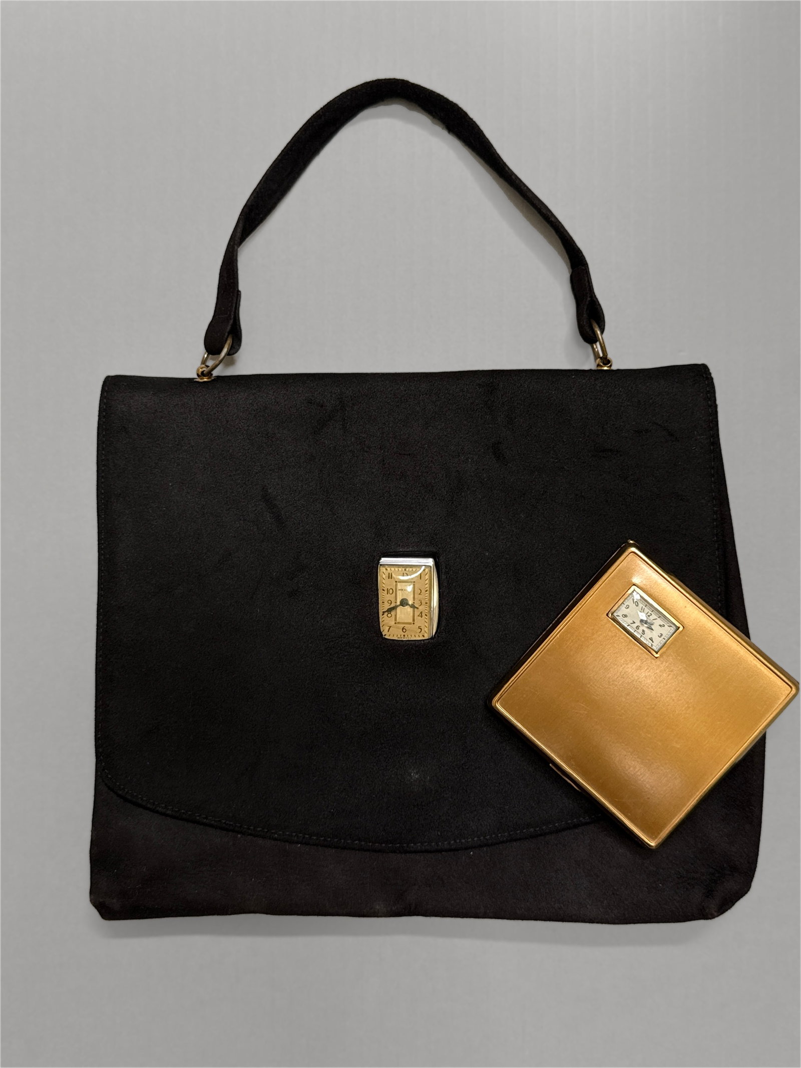 Vintage 1930s 40s Suede "Watch Bag" Purse & Illinois Watch Case Co. Makeup Compact: Vintage early to mid 20th c novelty surrealist black suede top handle "watch bag" and its similarly matched mechanical watch makeup powder compact. A rectangular New Haven mechanical clock displayed t