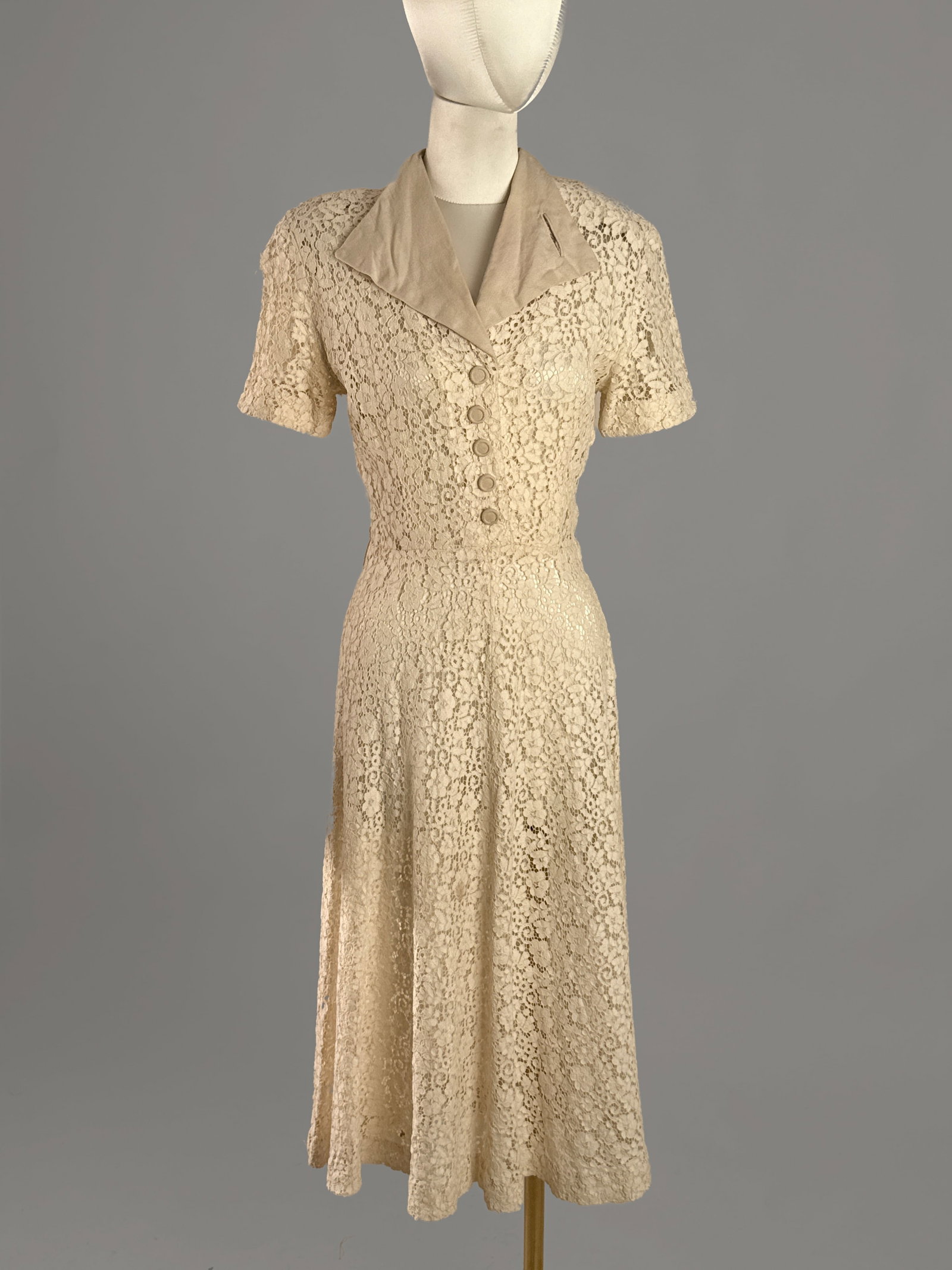 Vintage Late 1930s / Early 1940s Cream Floral Lace Day Dress: Late 1930s to early 40s wartime era vintage lace dress in a soft cream ivory hue. The dress features an openwork floral lace pattern, tailored silhouette, structured padded shoulders, short sleeves, a