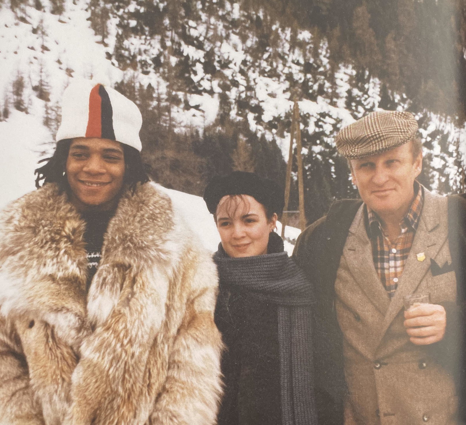 Jean-Michel Basquiat - Basquiat, Bartlett and Bischofberger, 1983: JEAN-MICHEL BASQUIAT (1960-1988) Jean-Michel Basquiat, Brook Bartlett(then assistant and friend), and Bruno Bischofberger, 1983 Print in Colors 9 1/4" x 8" Jean-Michel Basquiat was an influential Afri