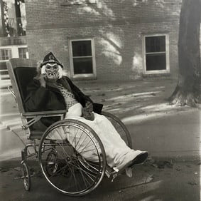 Diane Arbus - Masked Woman in a Wheelchair, PA. 1970