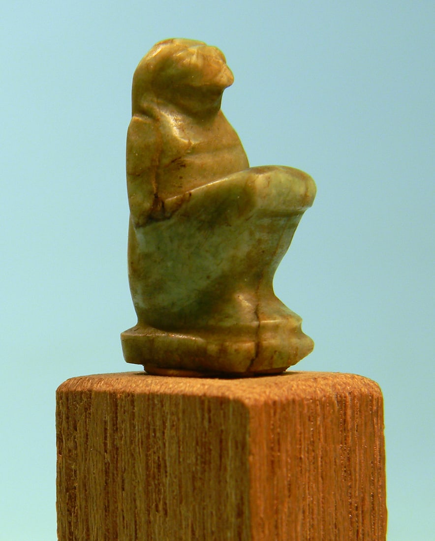 Egyptian Feldspar Sokaris Amulet: An ancient Egyptian green feldspar amulet of a seated falcon-headed god, likely Sokaris.Late Period.Ca. 700 - 30 BC. Height: 7/8 in. (2.3 cm).Falcon headed deities without specific headdresses are dif