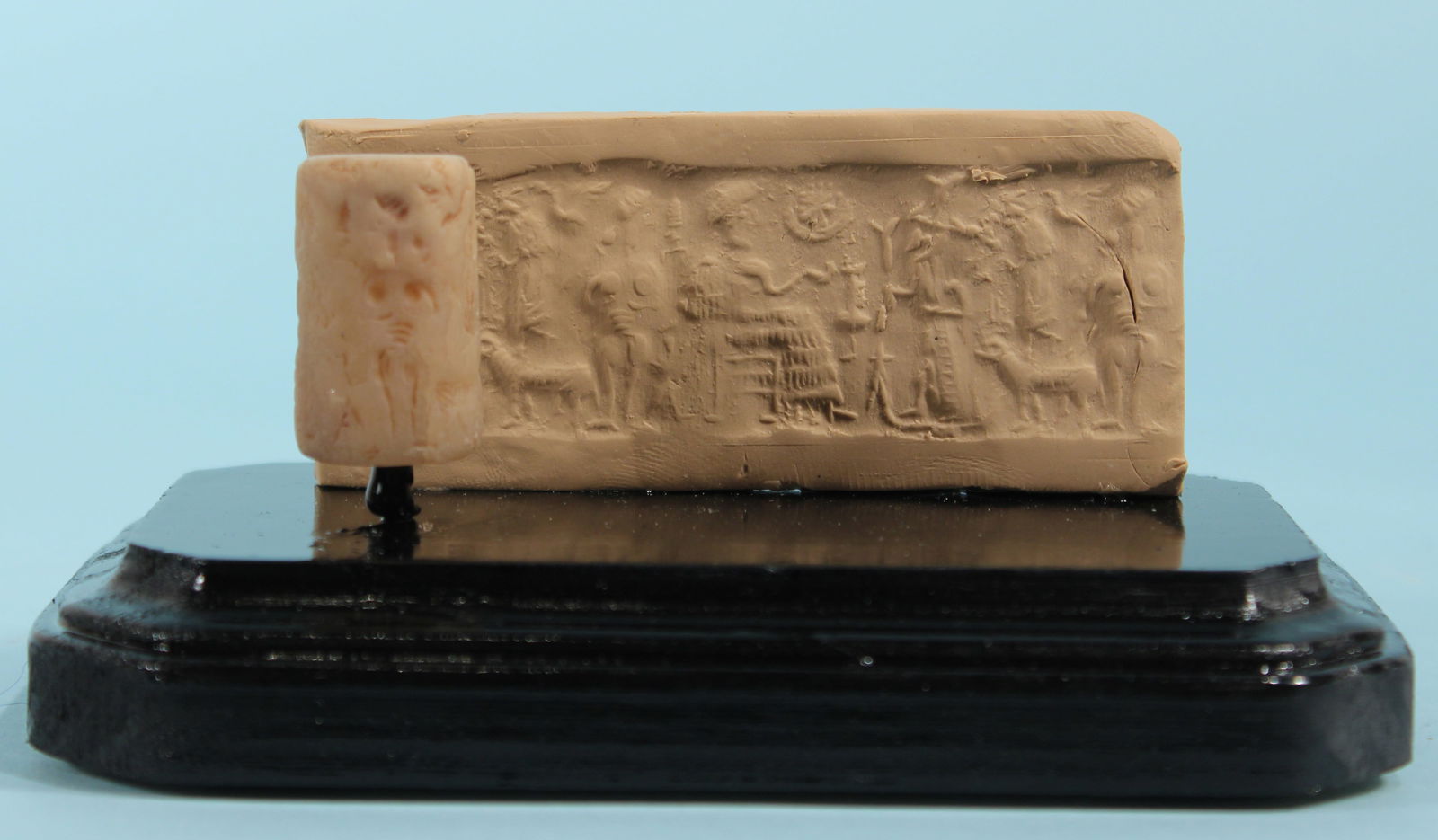 Old Babylonian Alabaster Cylinder Seal: An ancient Old Babylonian alabaster cylinder seal depicting a male figure leading a goat, followed by a nude female figure and approaching a seated figure, probably a god or a king.Old Babylonian Peri
