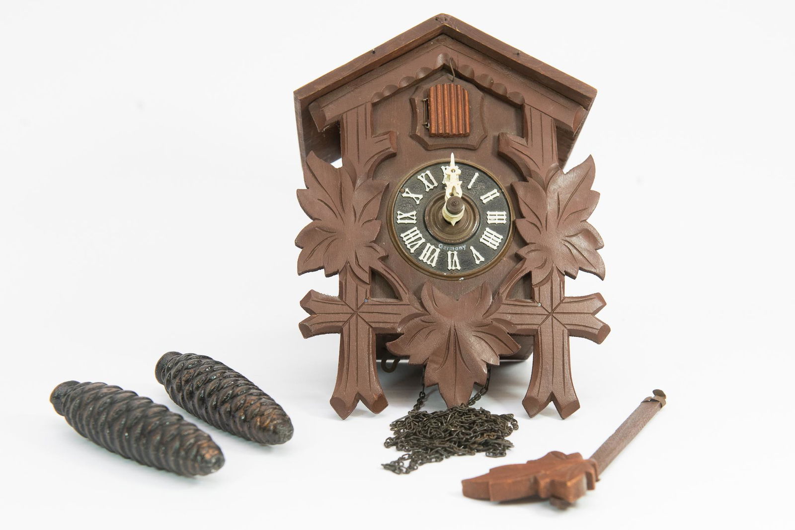 Small Wooden Cuckoo Clock: This lot features (1) Small Wooden Cookoo Clock. Back is marked "Germany" and all parts are included. Untested. Size 8.5"H X 6"W Condition Good Condition