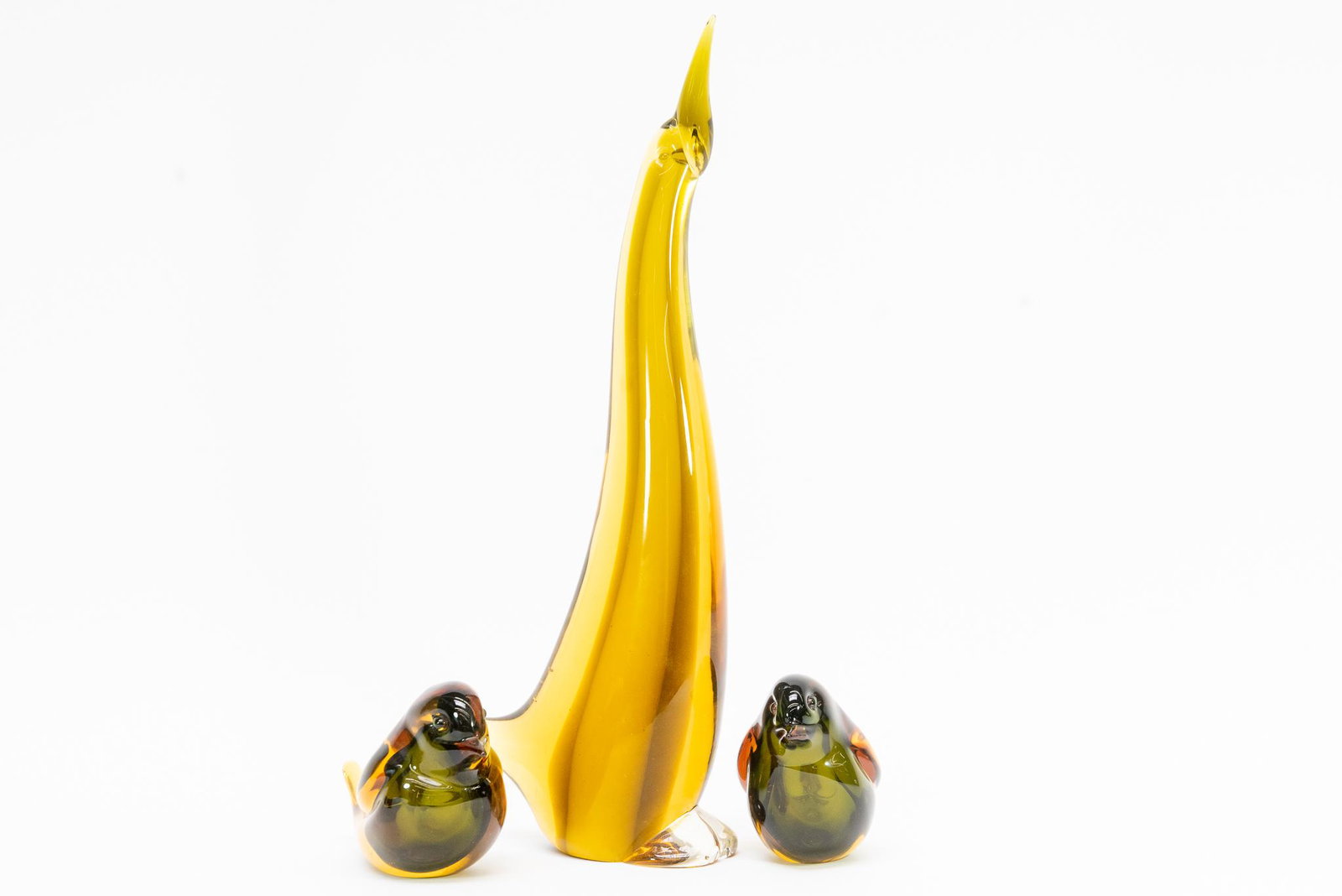 Glass Penguin & Birds: This lot features (1) Amber Glass Penguin. Polished Base and unmarked. Also included is (2) Sommerso Glass Birds. Polished Bases and unmarked. Condition Good Condition