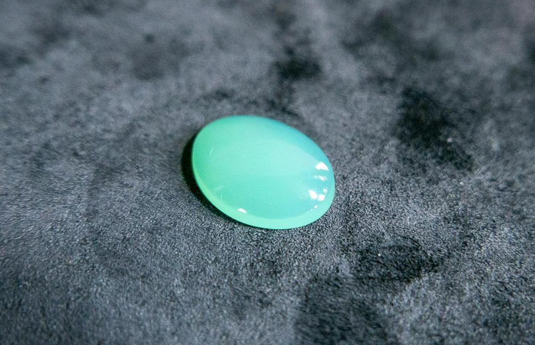 6.77CT OVAL CUT CHRYSOPRASE: One 17 x 13 oval cut chrysoprase 6.77ct consistent opaque in clarity, pale green color. Appraised for $270 in 1996 by Bouchér Jewelers. Confirmed by third party with Salem Auction House. Conditio
