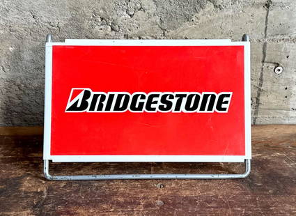 BRIDGESTONE TIRES TIRE STAND SIGN: Bridgestone Tires fold-out single sided tire stand advertising sign. On March 1, 1931, in Kurume, Fukuoka, Japan, Shojiro Ishibashi founded Bridgestone, the company that is now one of the world's
