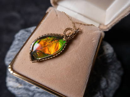 GOLD-FILL AMMOLITE NECKLACE: A gorgeous gold-filled Ammolite necklace. 18 inches chain length. Comes in a beige jewelry box.Size1"H 3"L 2.5"WConditionGood condition.